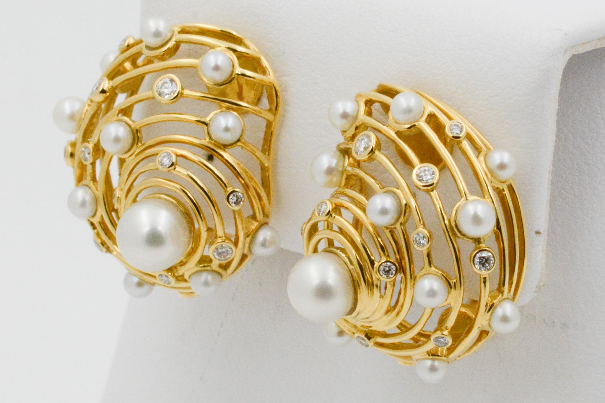 From Trianon, these 18k yellow god Newport clip earrings feature a wire shell design with 24 white pearls and 24 round diamond accents weighing .27ctw. Signed Triannon
