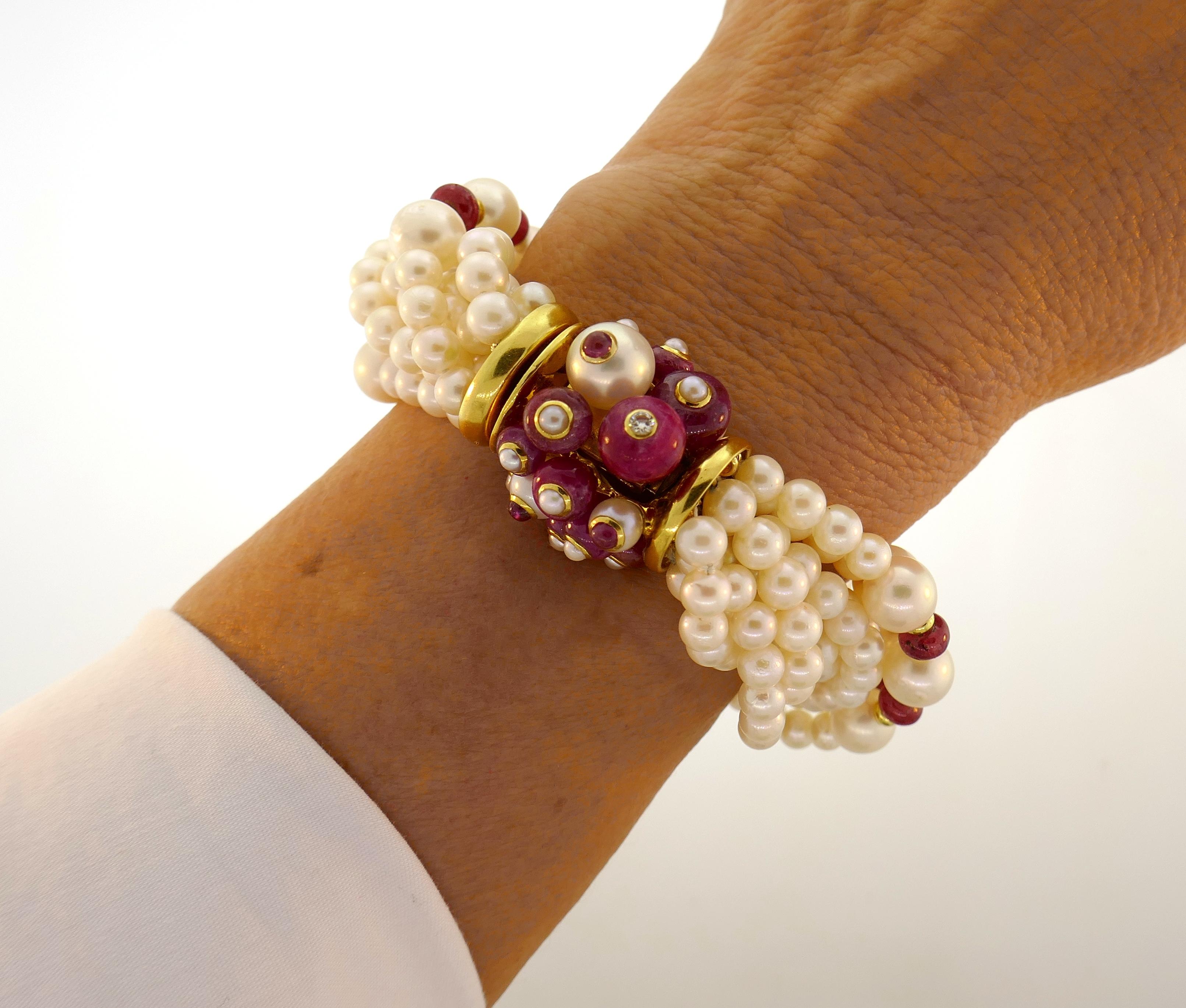 Lovely pearl with ruby accents bracelet created by Trianon. Chic, elegant and wearable, the bracelet is a great edition to your jewelry collection.
The bracelet is made of eight pearl strands accented with ruby beads and finished with 18 karat