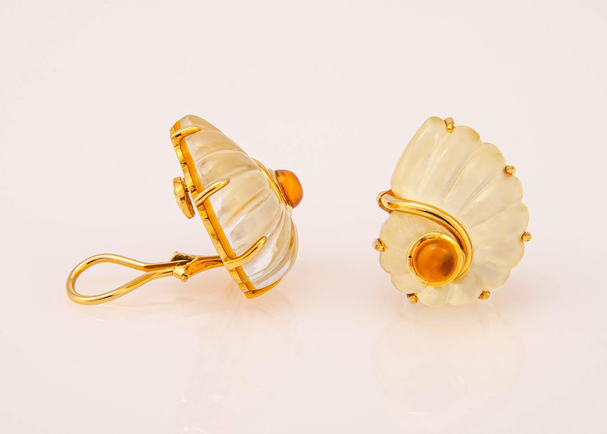 Trianon features carved rock crystal , a cabochon citrine and backs it with mother of pearl . A neutral easy to wear design. Just over 1 inch in size.