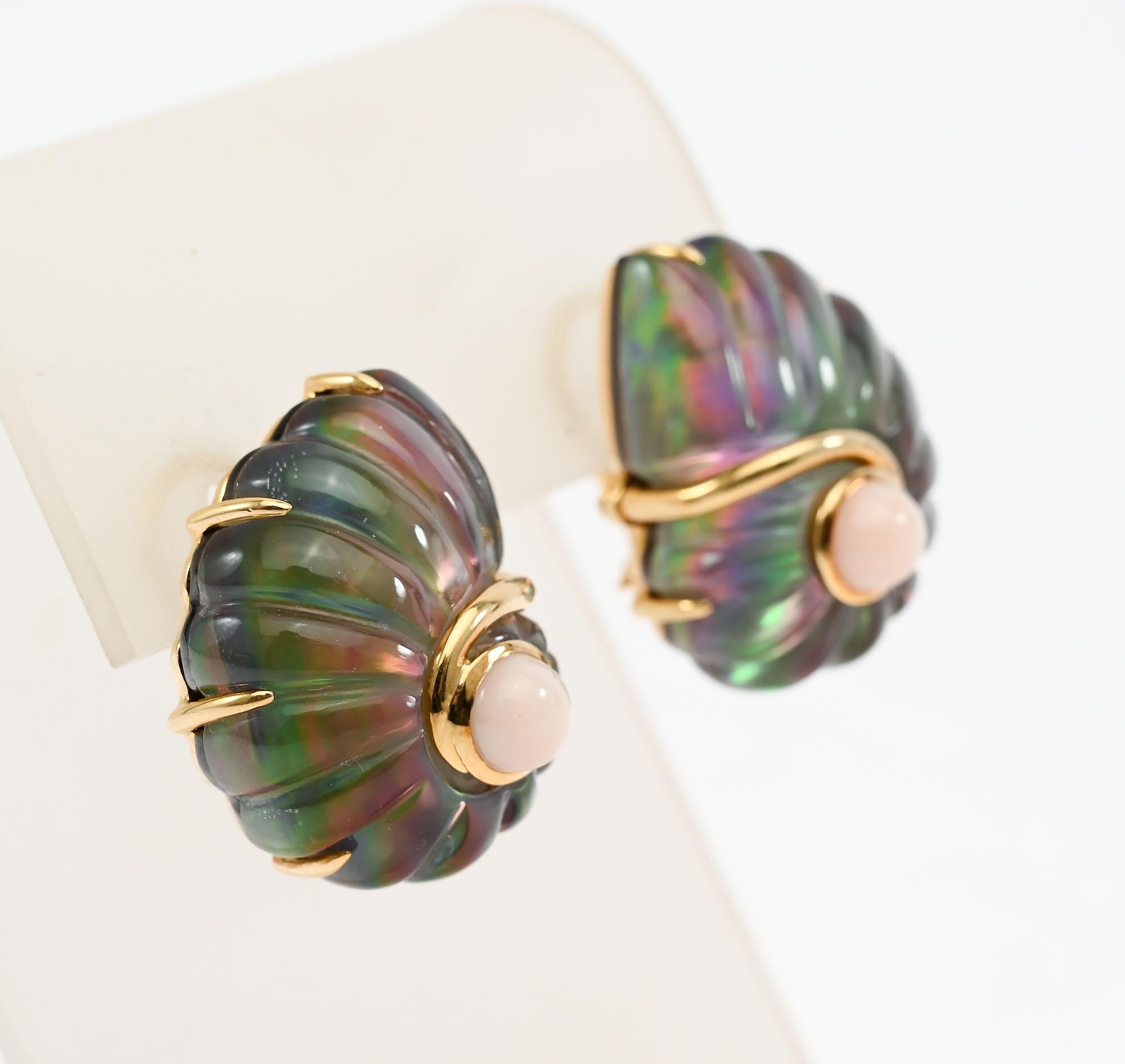 Gracefully curved shell earrings by Trianon. The primary stone is mother of pearl with a subtle iridescence. They are centered with a cabochon coral that picks up the pink of the  mother of pearl.
Backs are clips and posts.