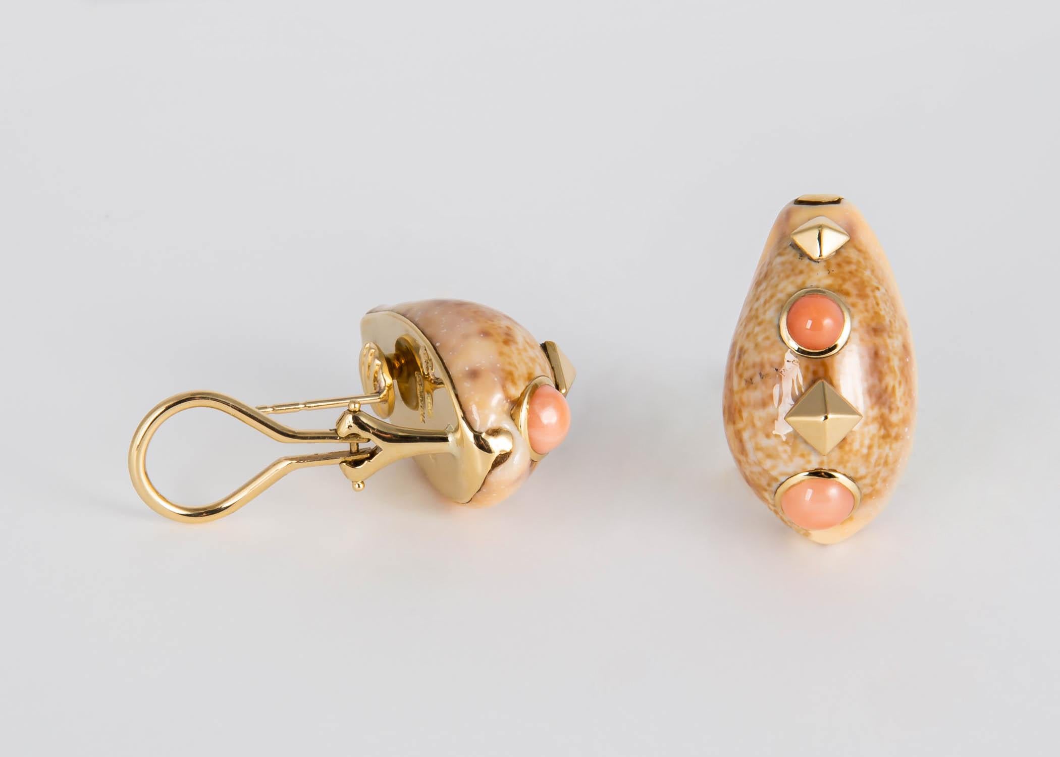 Trianon the sister company to Seaman Schepps is known for their beautiful natural shell earrings. This soft tan colored shell is accented with 18k gold and pinkish orange coral.  1 inch in size. 