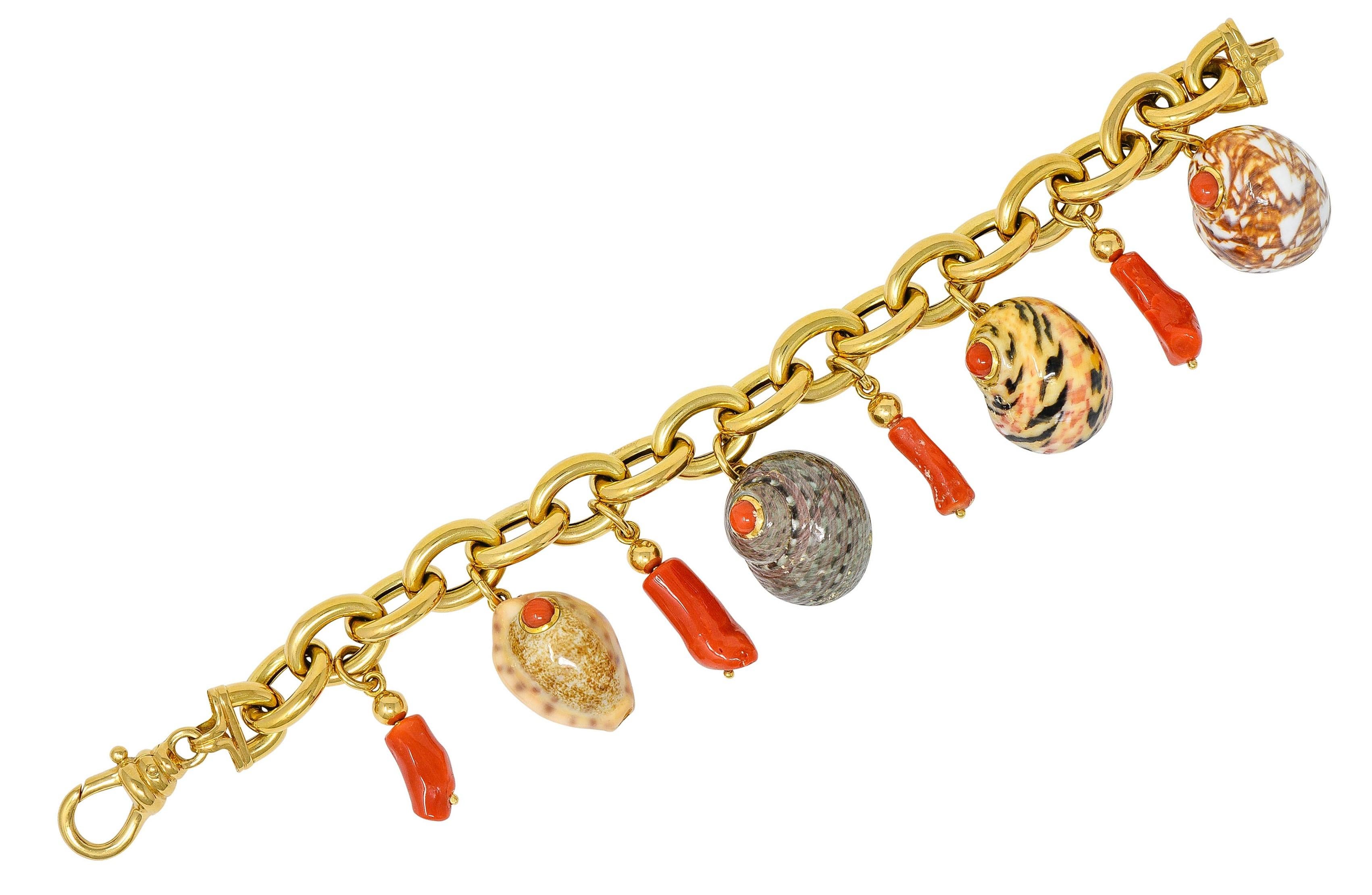 Chunky charm bracelet comprised of puffed oval links, high polished

Suspending four dynamically formed seashells, glossed with delightfully patterned enamel; no loss

A round 4.5 mm coral cabochon accents each shell; bezel set

Shells alternate