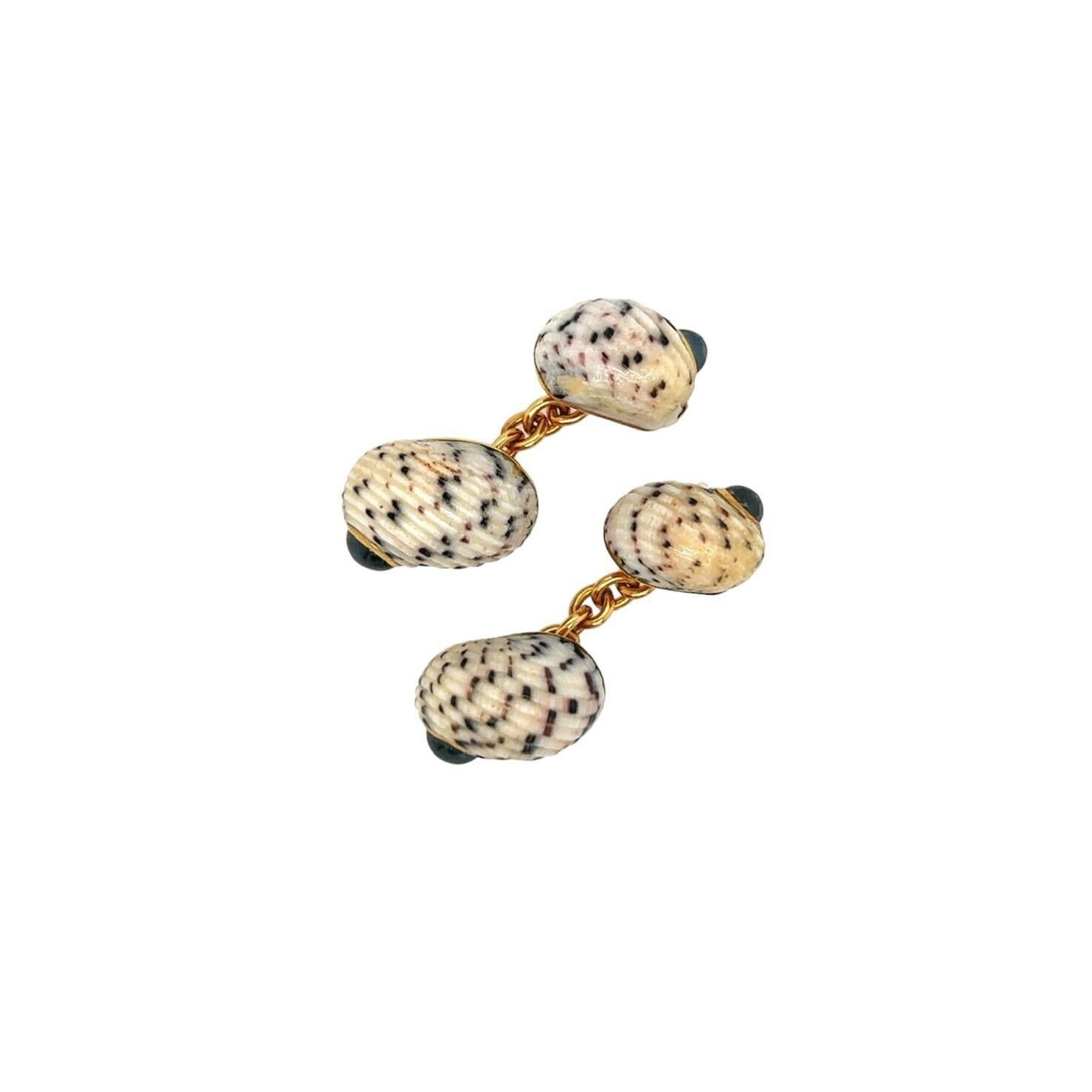  A pair of 18 karat yellow gold, speckled shell and sapphire cufflinks, signed Trianon.   