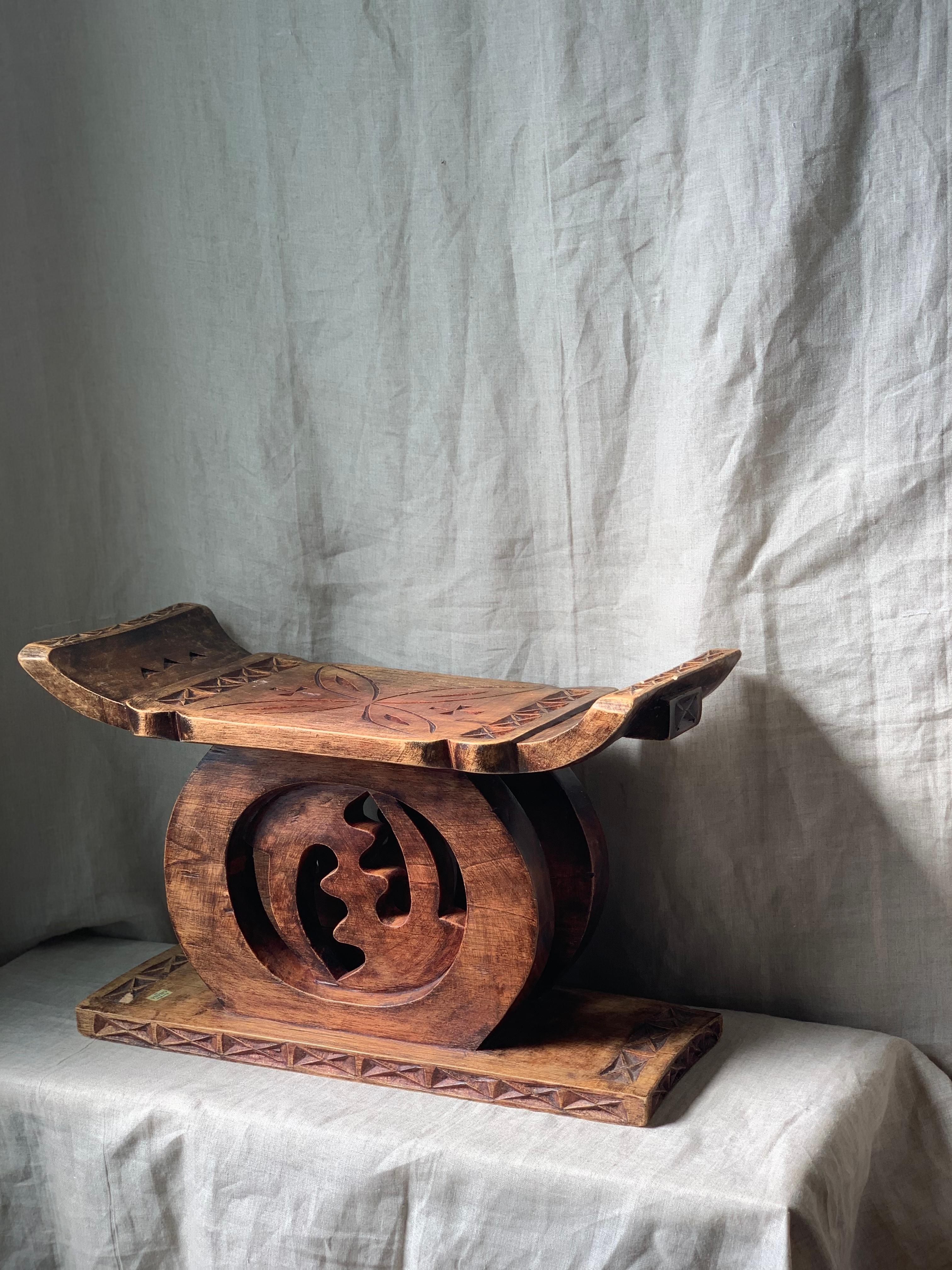 Hand carved teak African (Ghana) Ashanti stool. 

Carved at the center is the Adinkra 
