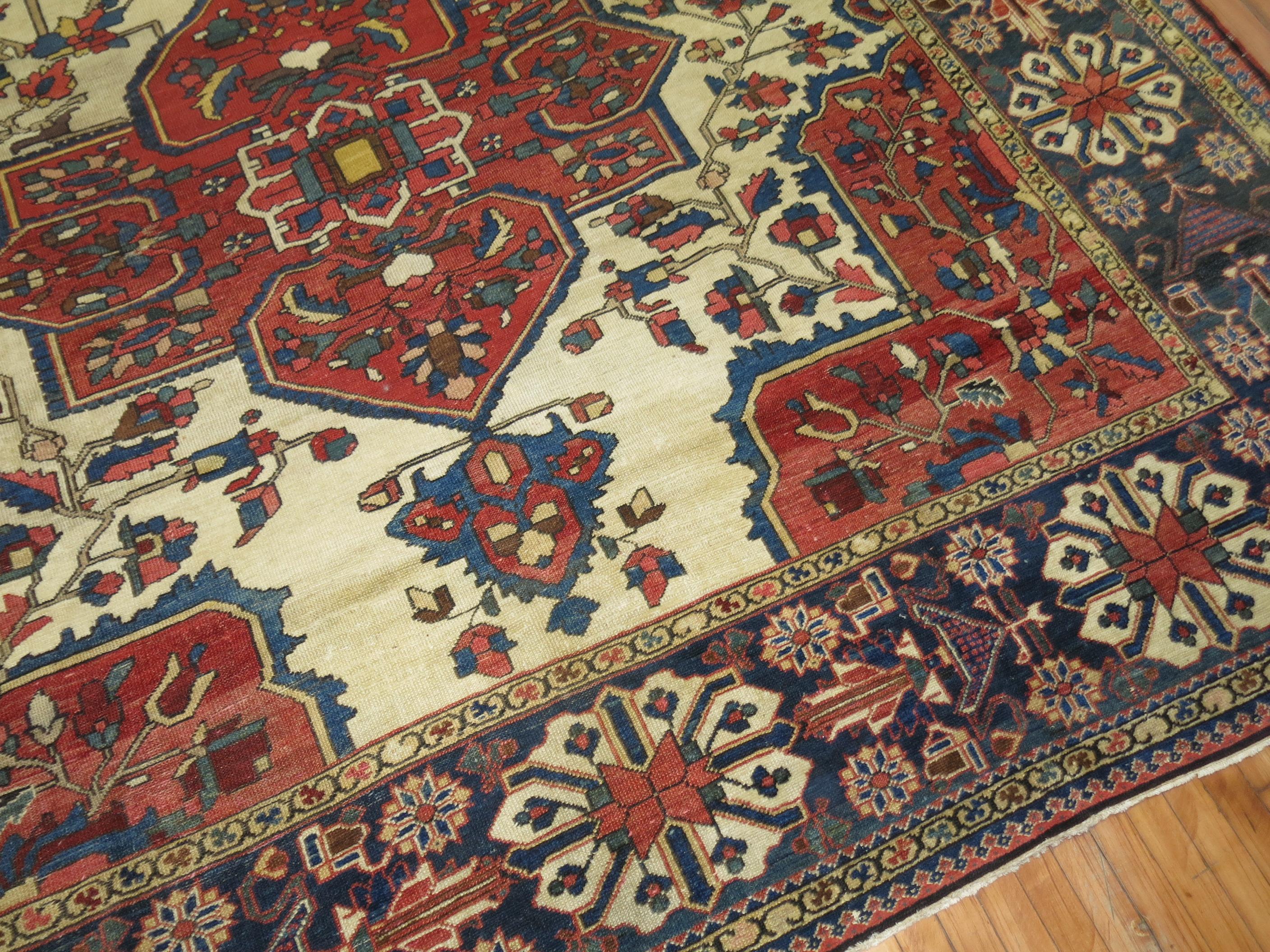 An antique Persian Bakhtiari rug with large scale all-over tribal medallion design on an antique white background.

Measures: 10'5'' x 16'8''.