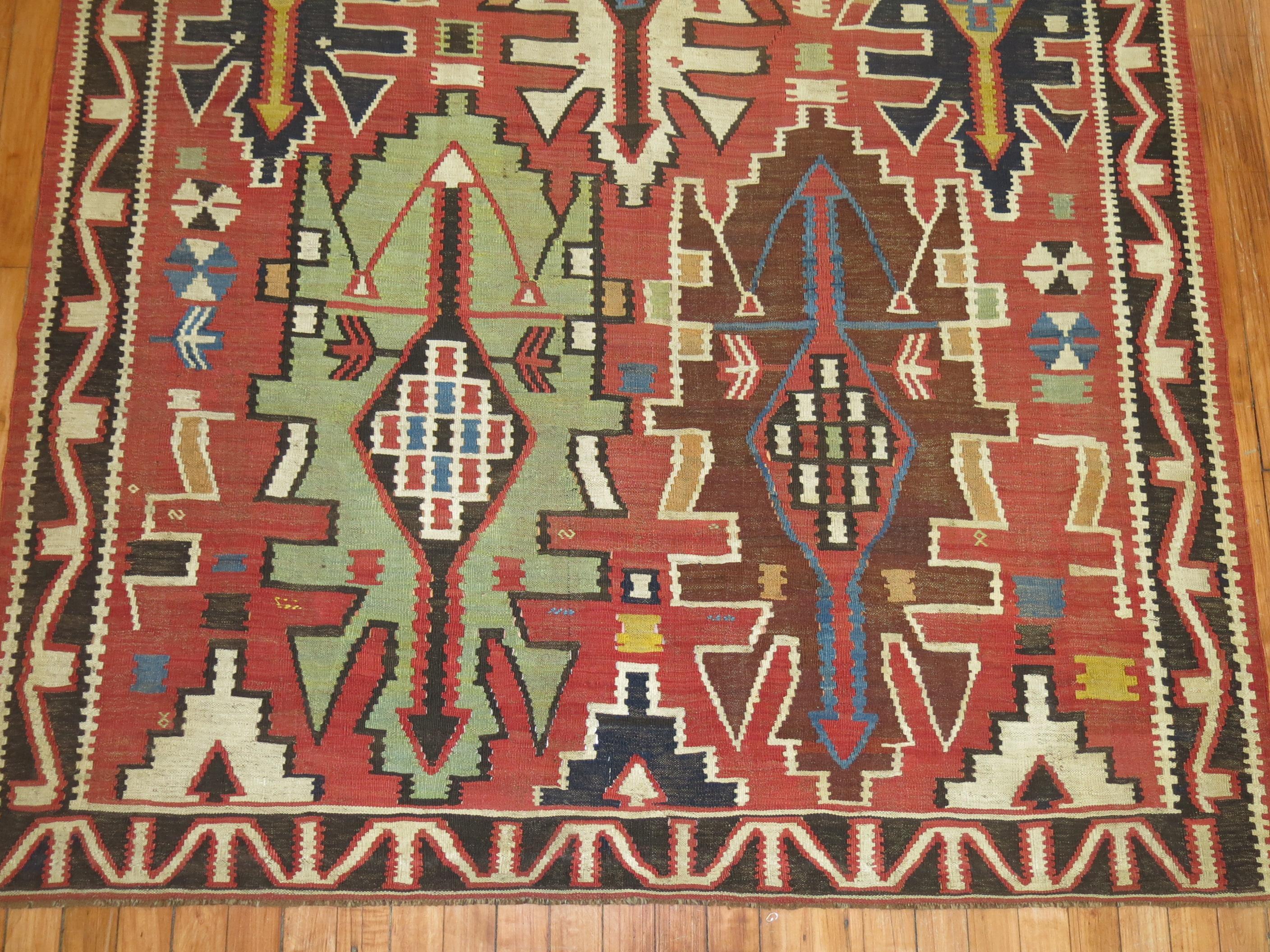 An intermediate size tribal Caucasian Shirvan rustic Kilim from the early 20th century

Measures: 4'10'' x 9'1