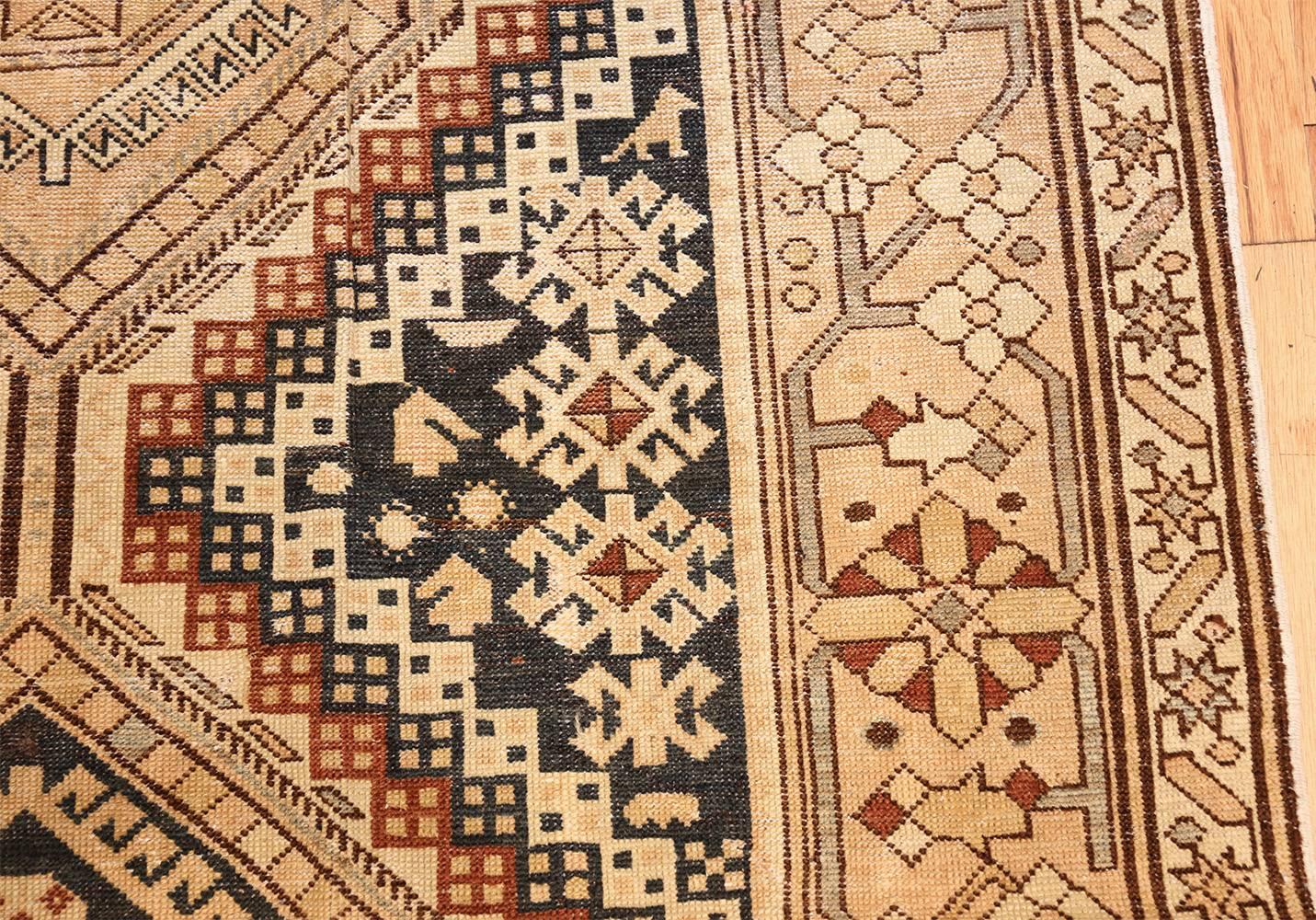 Antique Caucasian Shirvan rug, country of origin: Caucasia, date: circa 1920. Size: 6 ft. 3 in x 11 ft. 3 in (1.9 m x 3.43 m). This antique Caucasian rug features a creamy tone overlaid with patterns in black, white and red, with hints of pale blue.