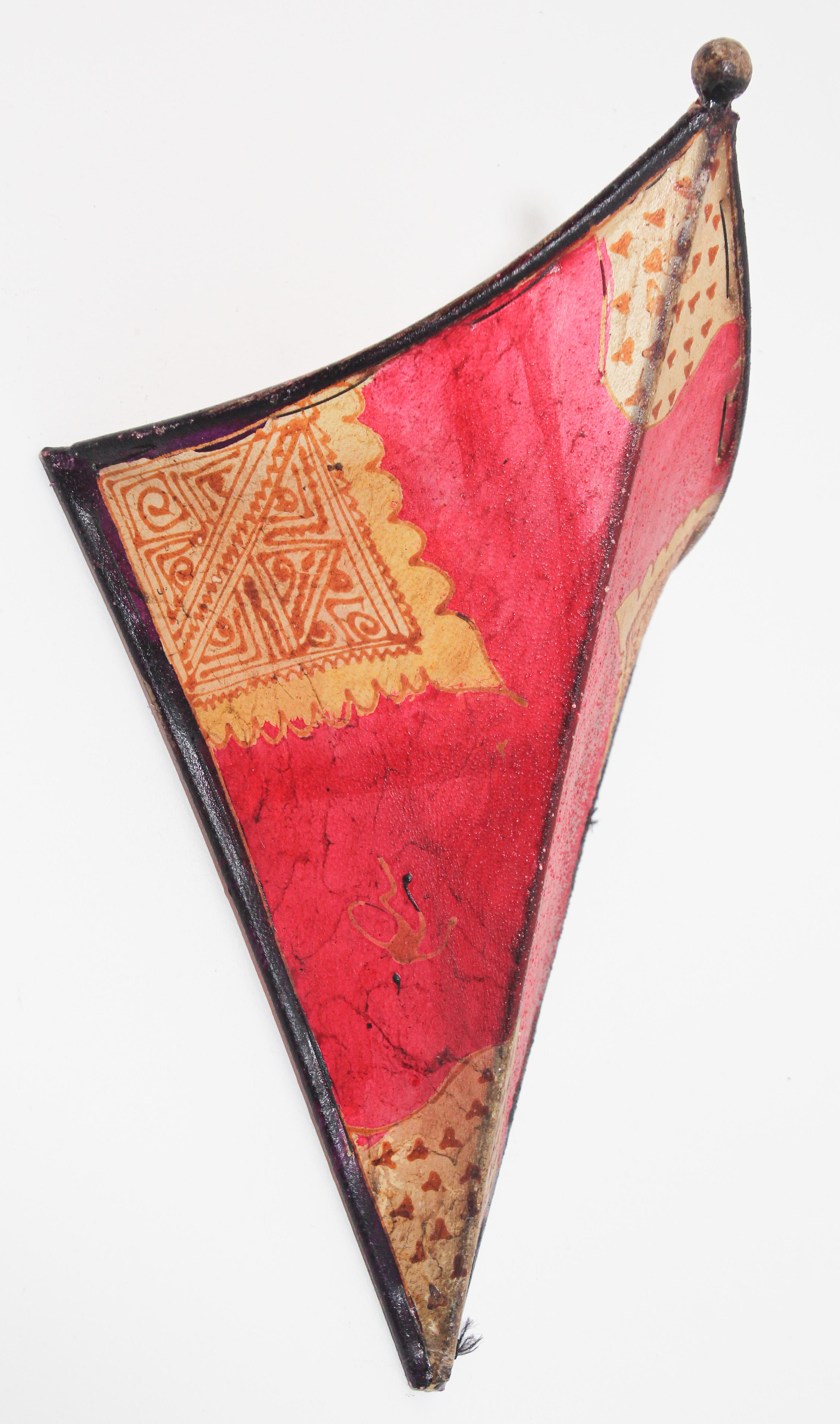 African Tribal Art parchment wall shade sconce featuring a large triangle hide form stitched on iron and hand painted surface.
These Moroccan Art pieces could be used as wall lamp shade.
Iron frame covered with hide parchment which has been hand