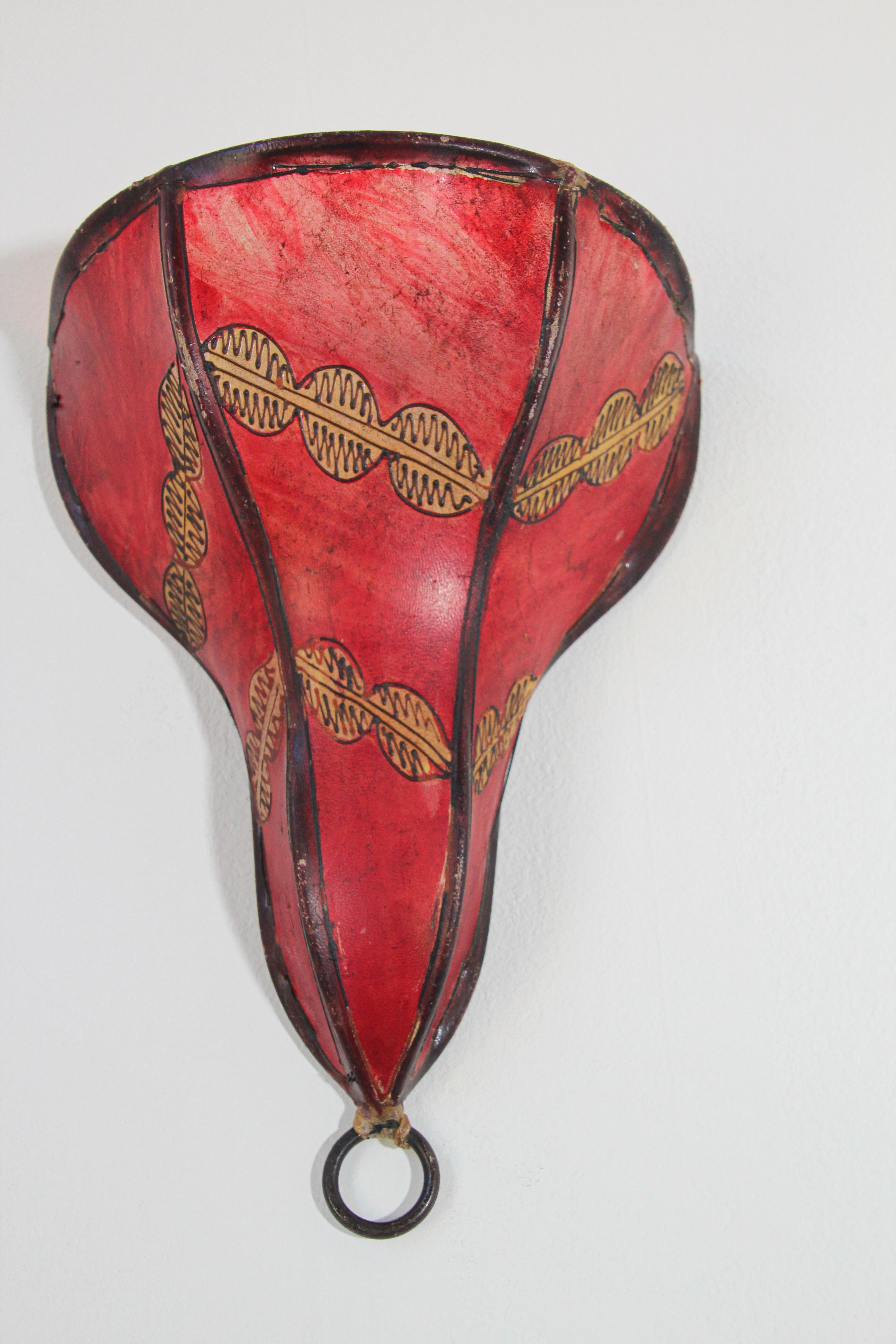 African Tribal Art parchment wall shade sconce featuring a large triangle hide form stitched on iron and hand painted surface.
These Moroccan Art pieces could be used as wall lamp shade.
Iron frame covered with hide parchment which has been hand