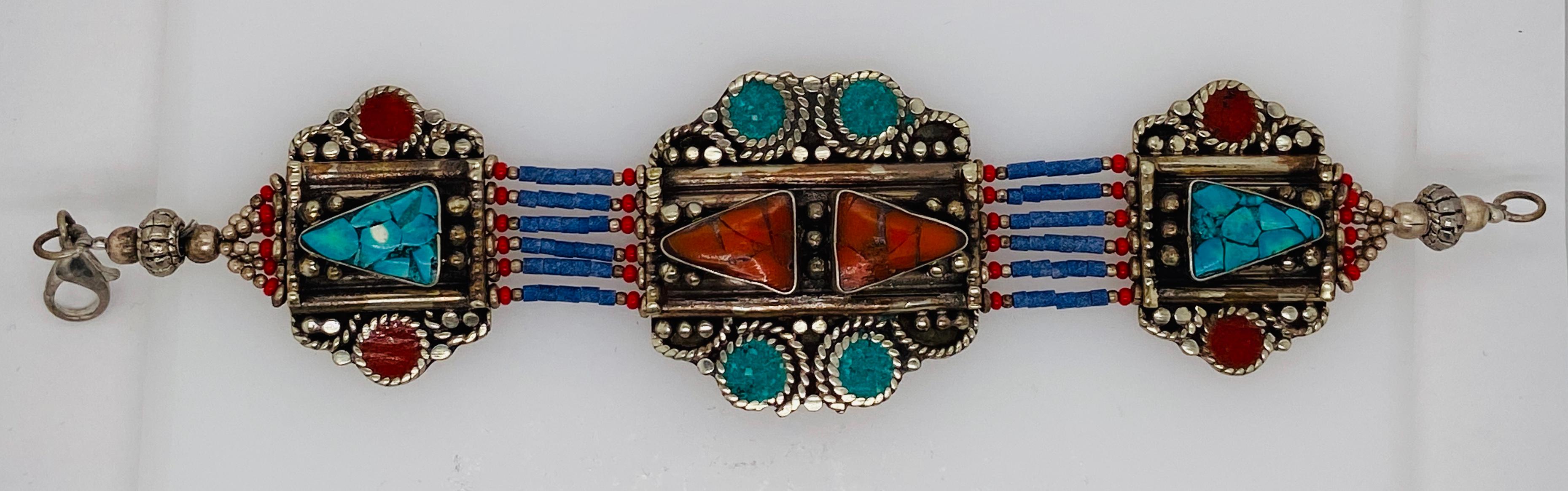 A stunning handmade MoroccanTribal Berber tribal pure silver bracelet. This beautiful and one of a kind piece of jewelry made around 1920s by the berber tribes in Morocco features genuine turquoise stores and other natural stones in red, blue and