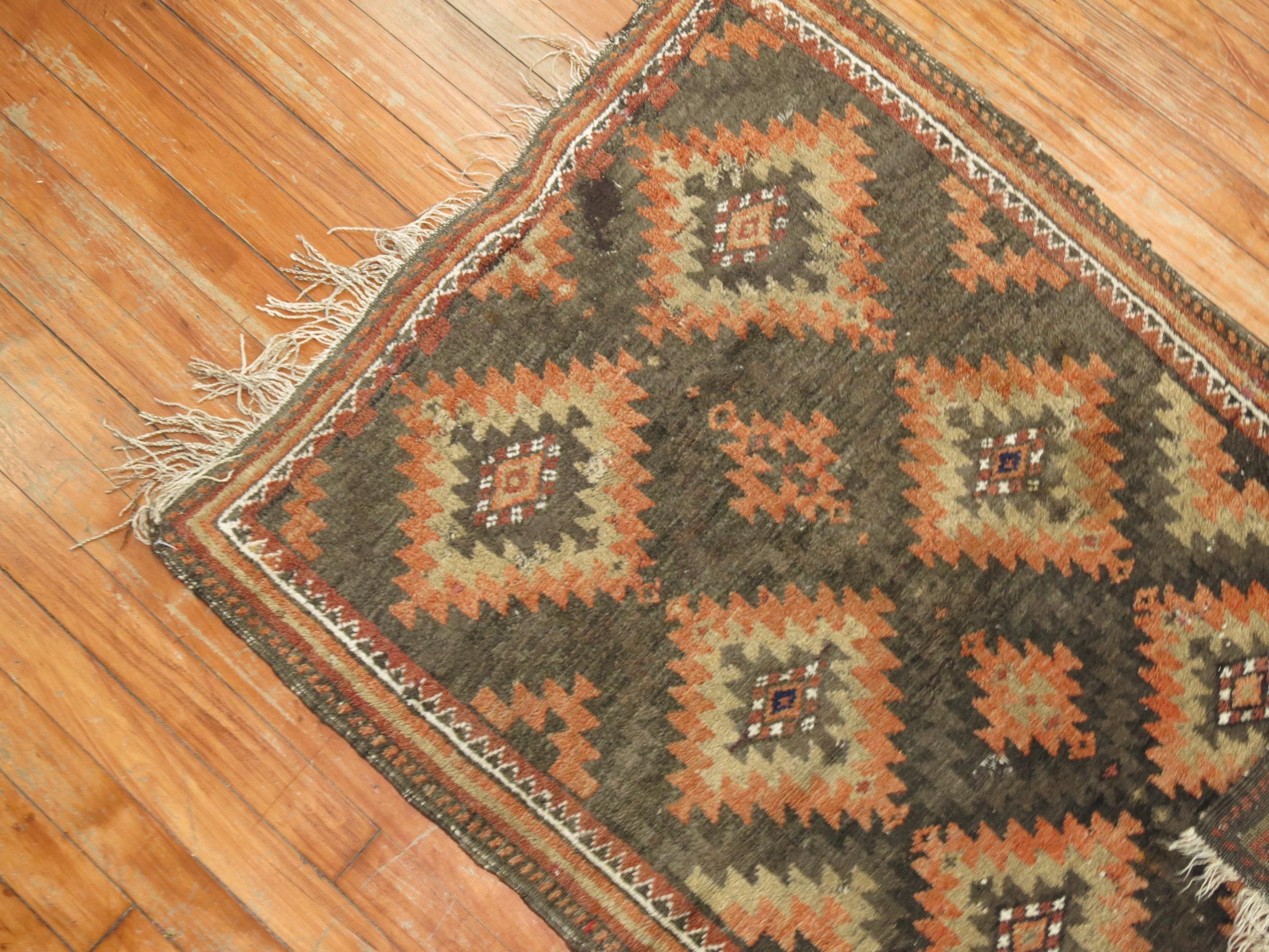 A tribal balouch rug from the early 20th century in brown and orange accents, circa 1930

Measures: 2'6” x 3'10”.