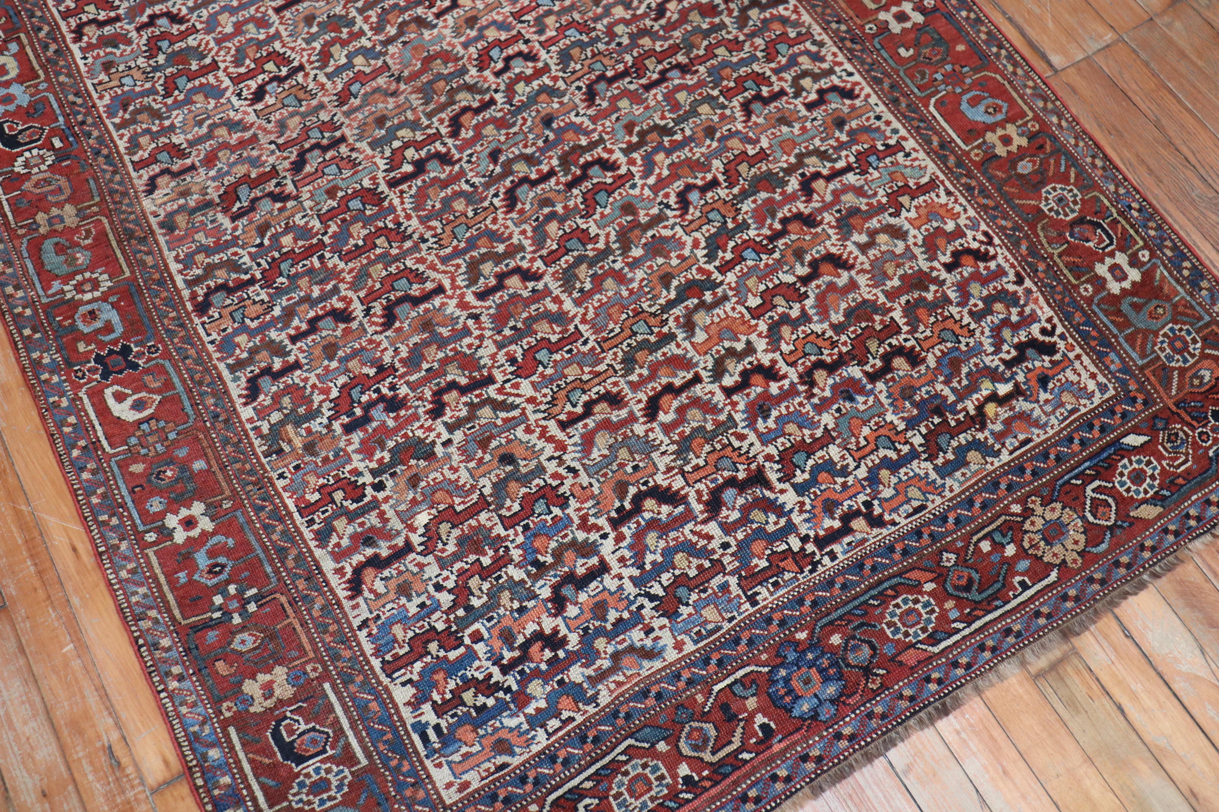 An early 20th century Persian Tribal Afshar Shiraz carpet with an all-over chicken motif on an ivory field, rustic accents

Measures: 4'2” x 5'11”.