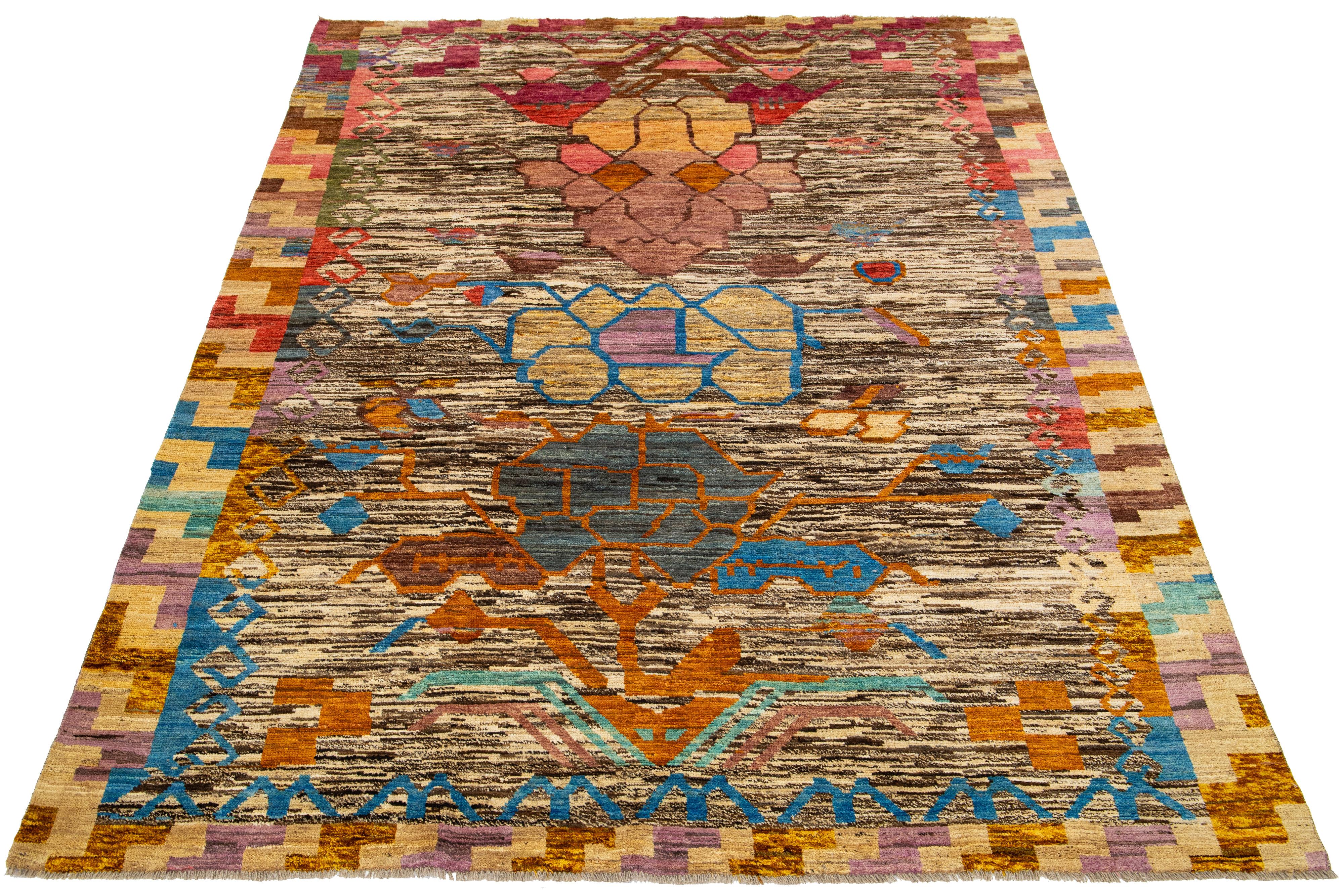 This modern Moroccan wool rug showcases a captivating Tribal pattern in a multitude of colors, adding vibrancy to any space. It features a beautiful beige and brown color field.

This rug measures 6'8