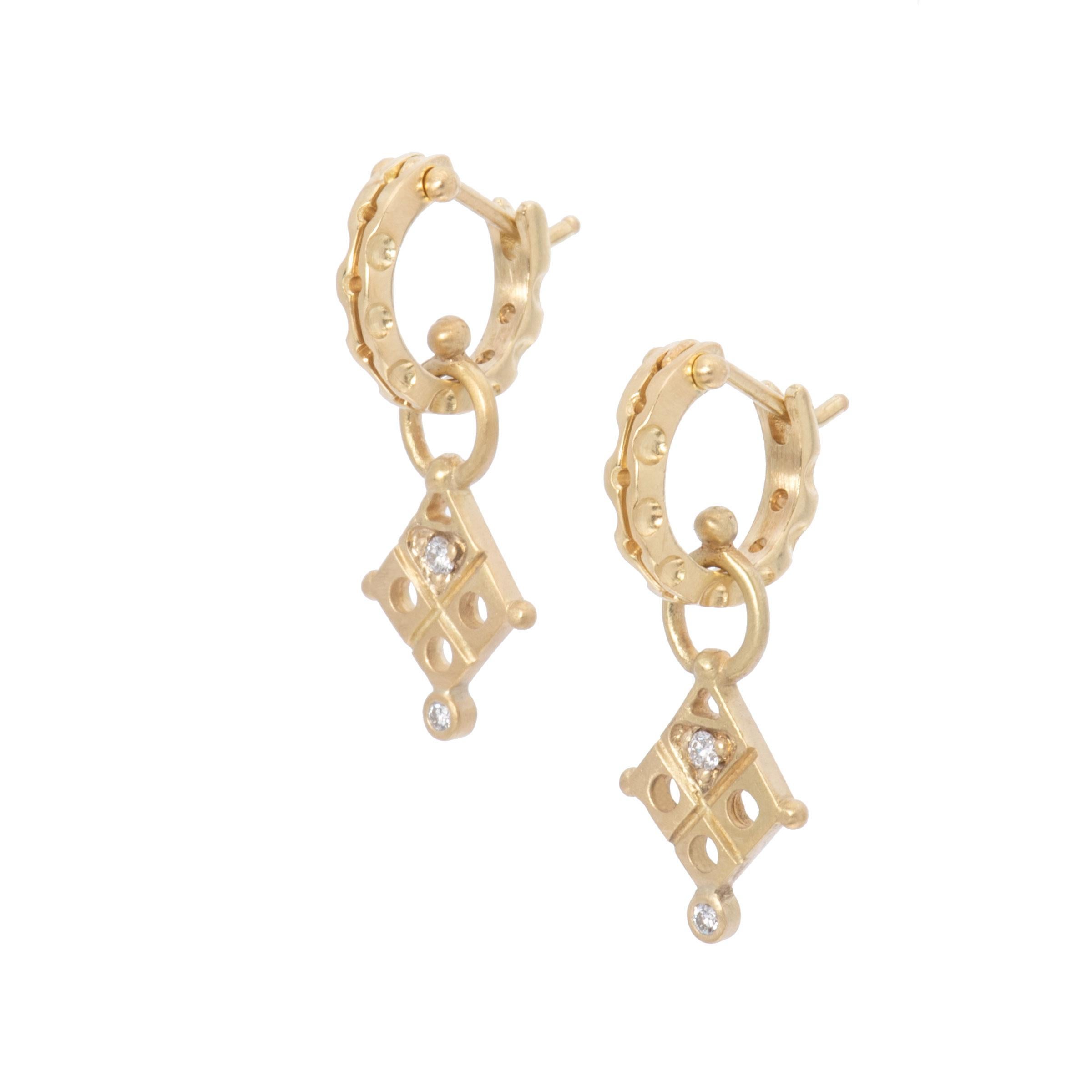 It's Midnight at the Oasis for our Tribal Diamond Drop Earrings in 18 Karat Gold. Satiny 18 karat gold diamond shapes are beaded at the cardinal points and deeply carved with a tribal design set with diamonds. The carved design of our cypress hoops