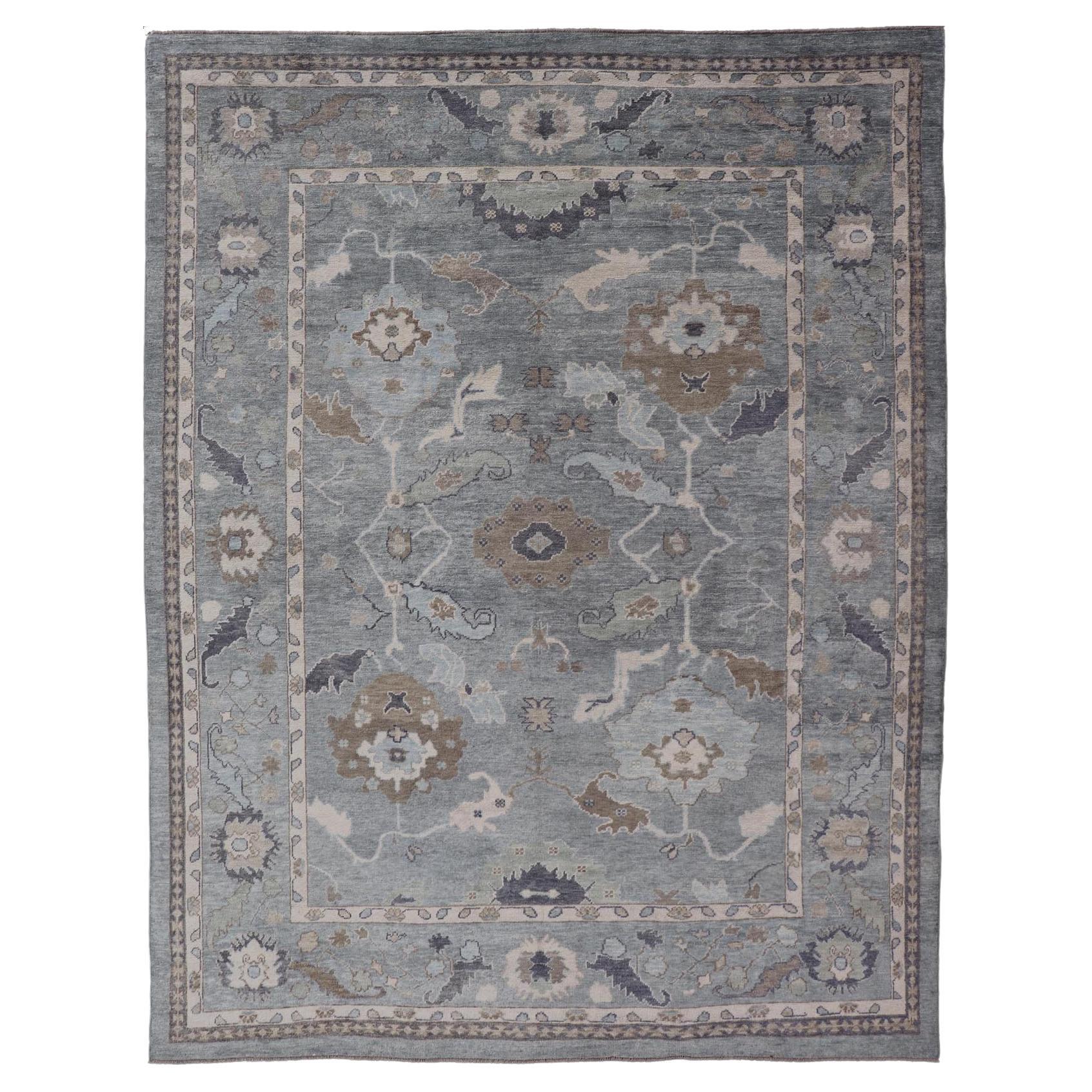 Tribal Floral Design Hand Knotted Turkish Oushak Rug with Blues and Brown For Sale