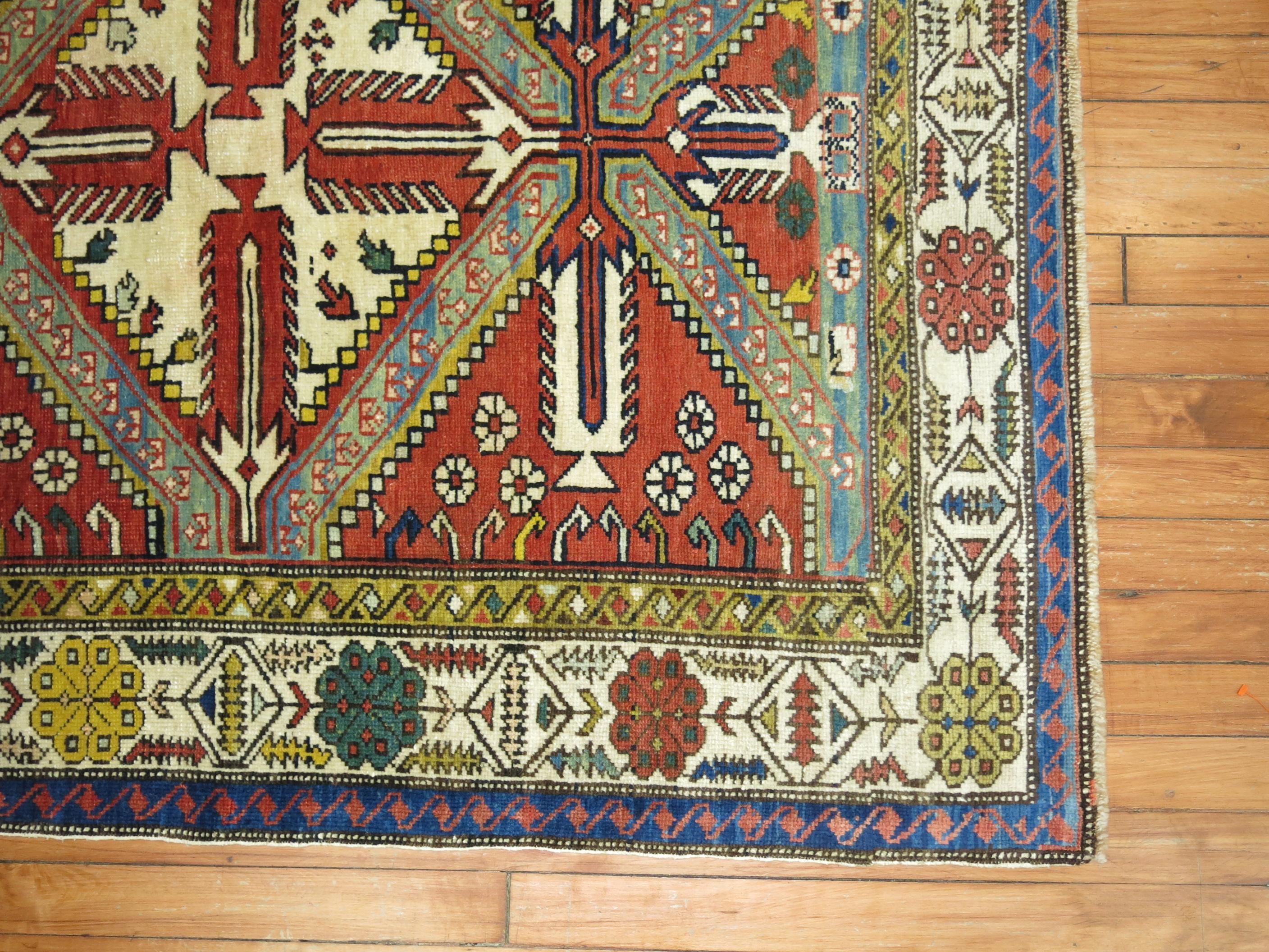 A geometric tribal looking Caucasian shirvan rug from the early 20th century.
Brick red field, earth accents in green and blue,

circa 1910. Measures: 3'8