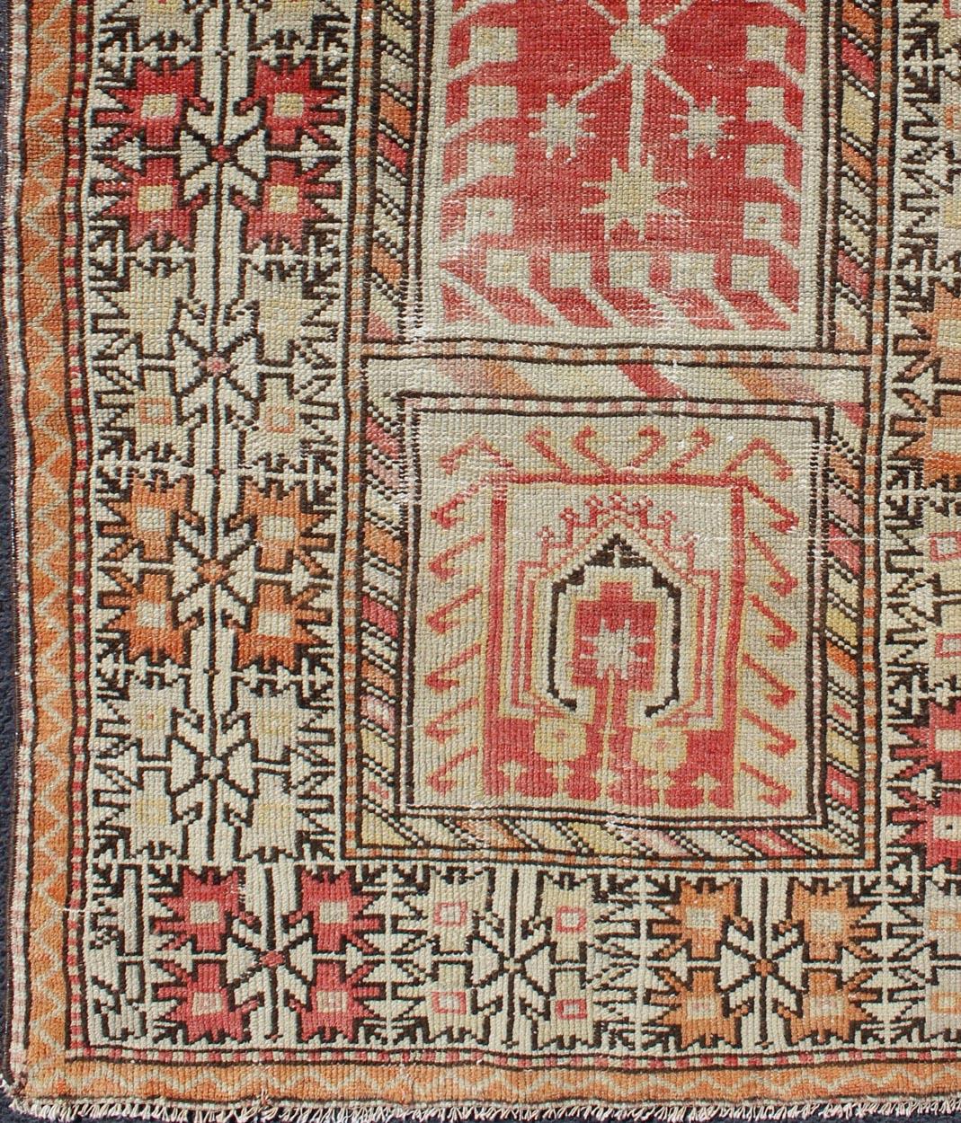 Antique Oushak rug from Turkey with Tribal and Geometric Motifs in Sunset-Colored Palette, rug gng-4743, country of origin / type: Turkey / Oushak, circa 1920.

This striking antique Turkish Oushak rug bears a dazzling tribal-geometric design
