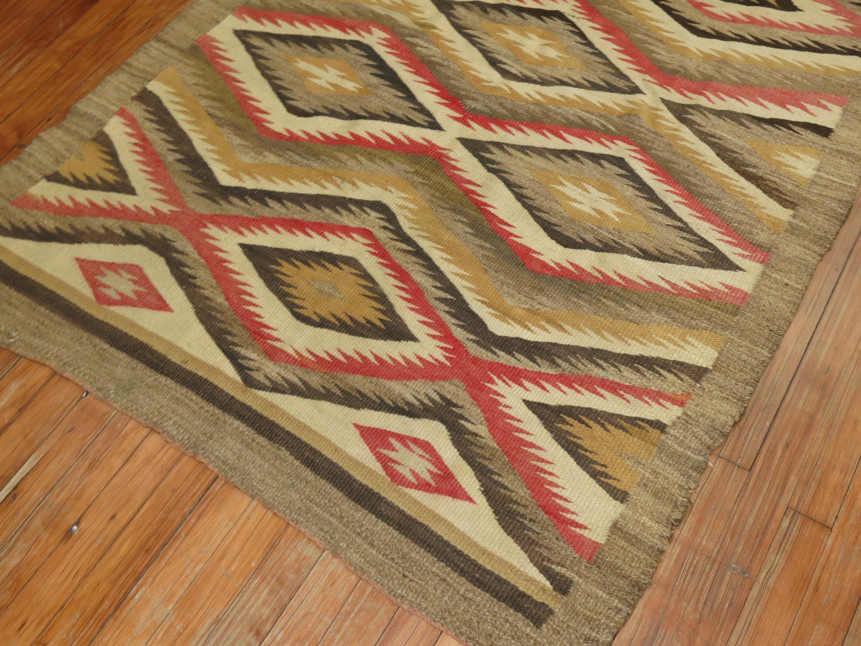 A highly decorative 20th century American Navajo Rug with an all-over geometric tribal design in red, brown accents on a camel field.

3'9'' x 5'2''
     