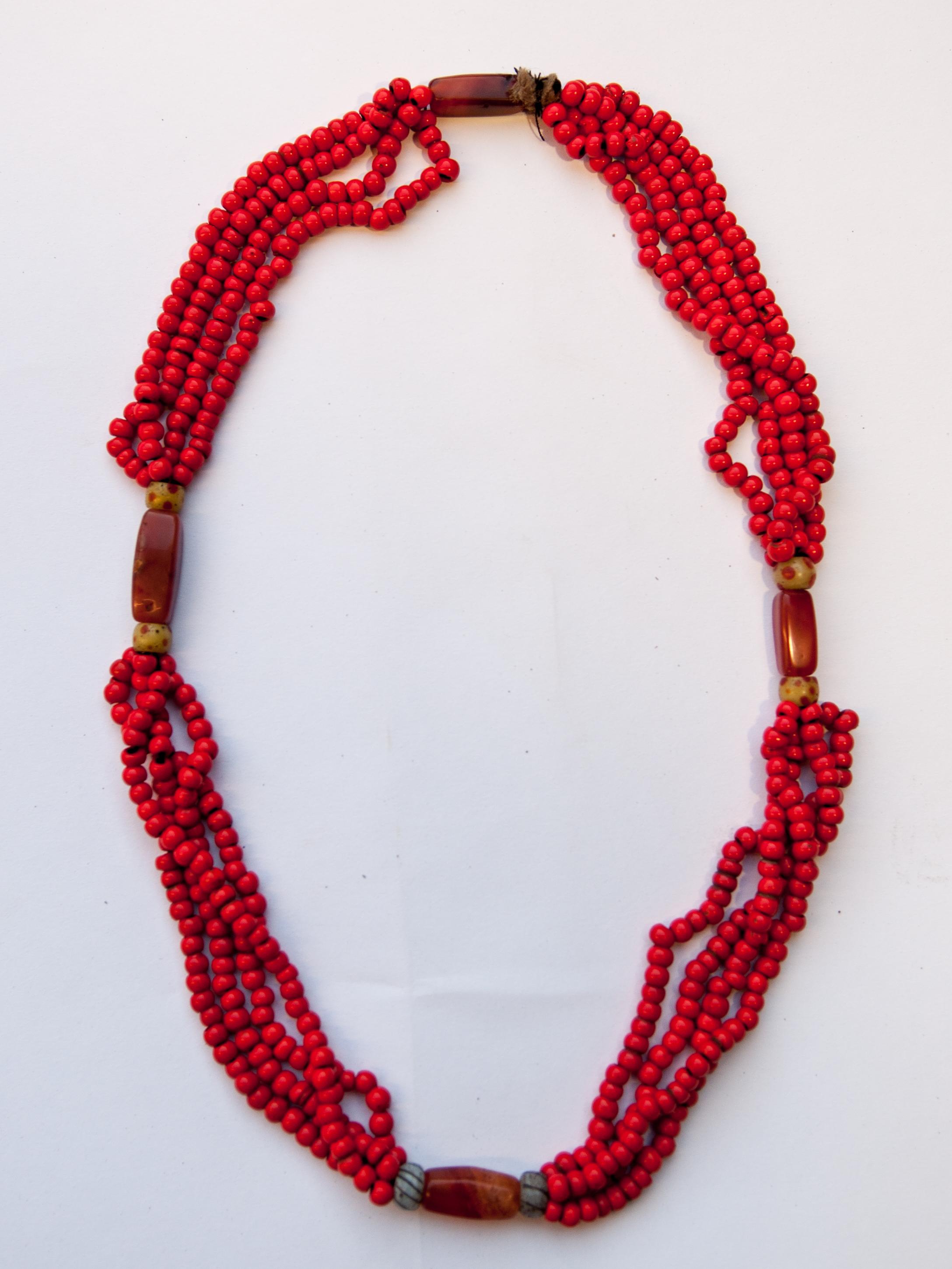 Tribal glass and carnelian bead necklace from Nagaland, NE India, mid-20th century.
The piece comprises rows of old red glass beads with carnelian and antique glass bead spacers.
Measurements: The outside diameter is approximately 10.5 inches,