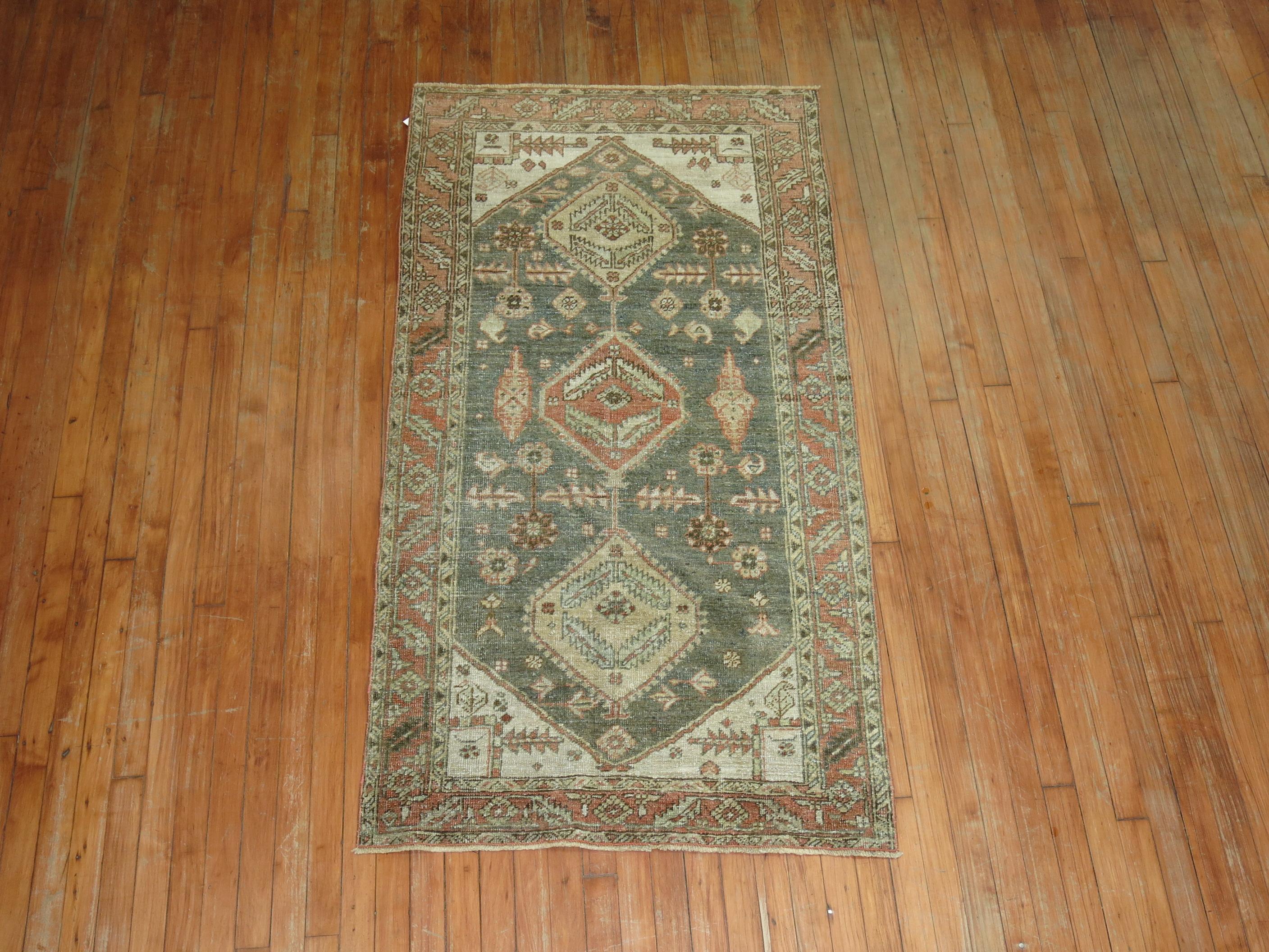 Earth color Persian Heriz Tribal rug with a geometric motif on a green ground, accents in ivory and terracotta, circa 1920.

Measures: 3'1” x 5'11”.