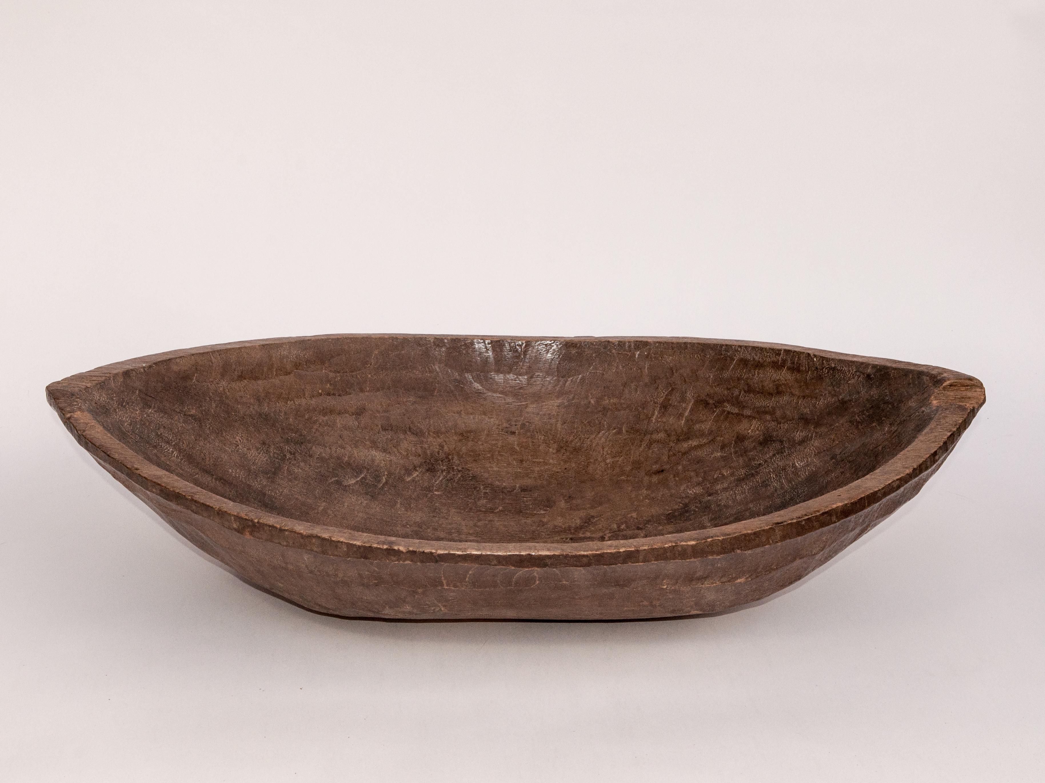 Tribal hand hewn wooden tray or bowl from the Mentawai Islands, early to mid-20th century.
Fashioned by hand from a single piece of local hardwood, this oval wooden tray was used to present food and fruits when receiving guests. This particular