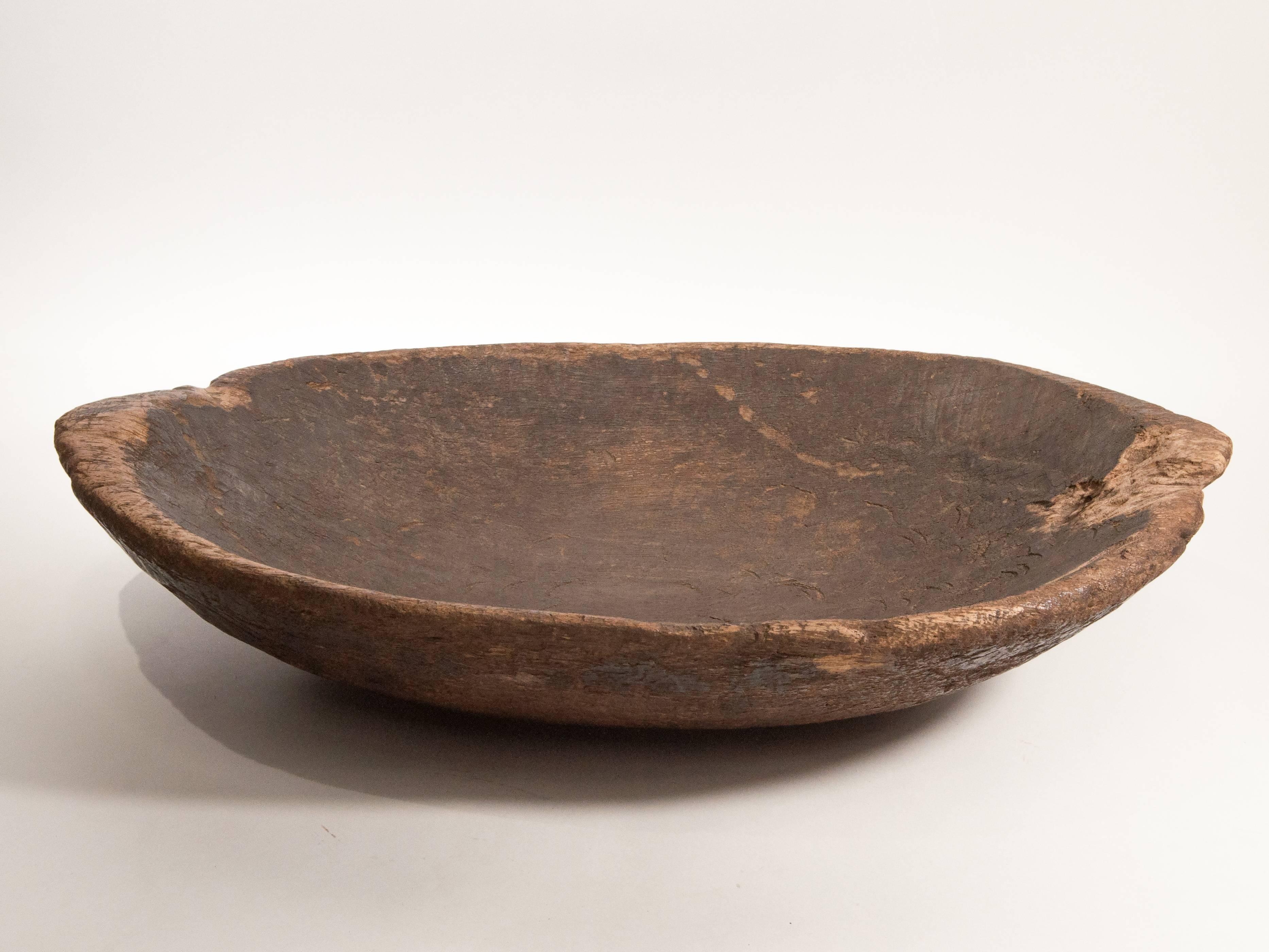 Tribal hand hewn wooden tray Mentawai Island, early to mid-20th century.
Fashioned by hand from a single piece of local hardwood, this oval wooden tray was used to present food and fruits when receiving guests. This particular tray retains its raw
