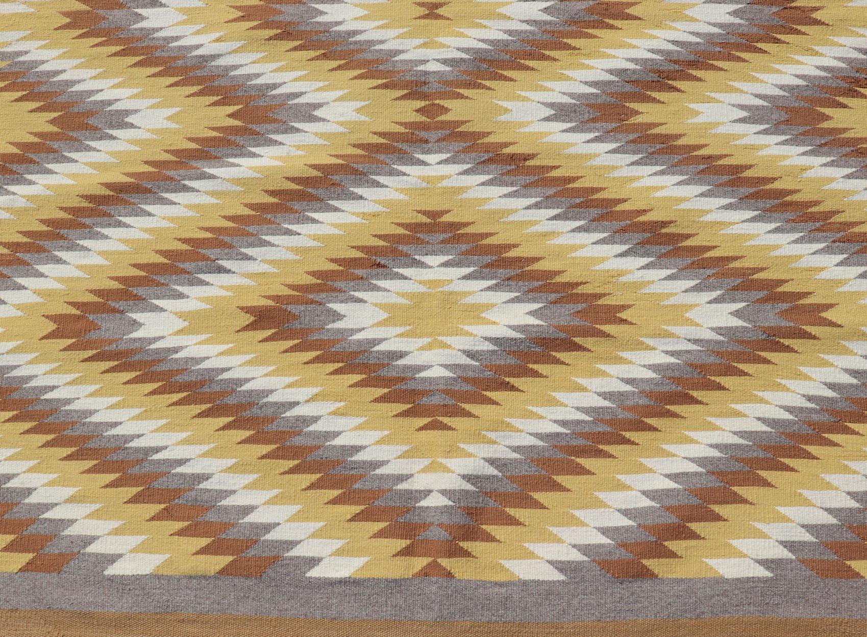 Tribal hand woven vintage Navajo Kilim with gold, gray, ivory, and brown. Keivan Woven Arts / rug / X23-0106, country of origin / type: America / Navajo, circa 1960.

Measures:4'6 x 6'0 

This intriguing Navajo Kilim, circa 1960 was woven in the