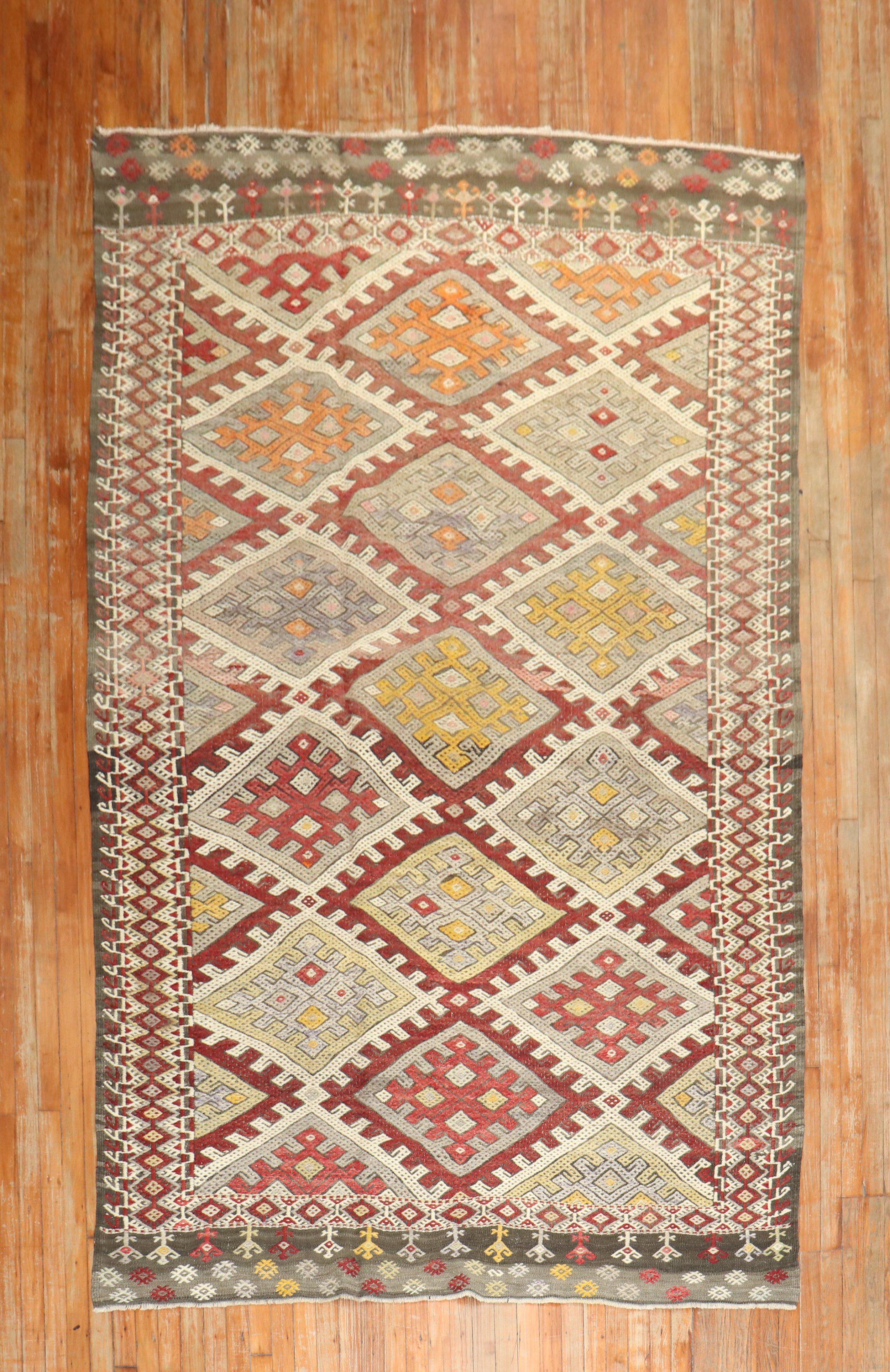 Mid 20th century Tribal Turkish Jajim kilim with a geometric desing with rustic colors

Measures: 6'11” x 10'5”

With the Jijim weaving technique, different colored threads are applied between the weft and warp threads, on the reverse of the