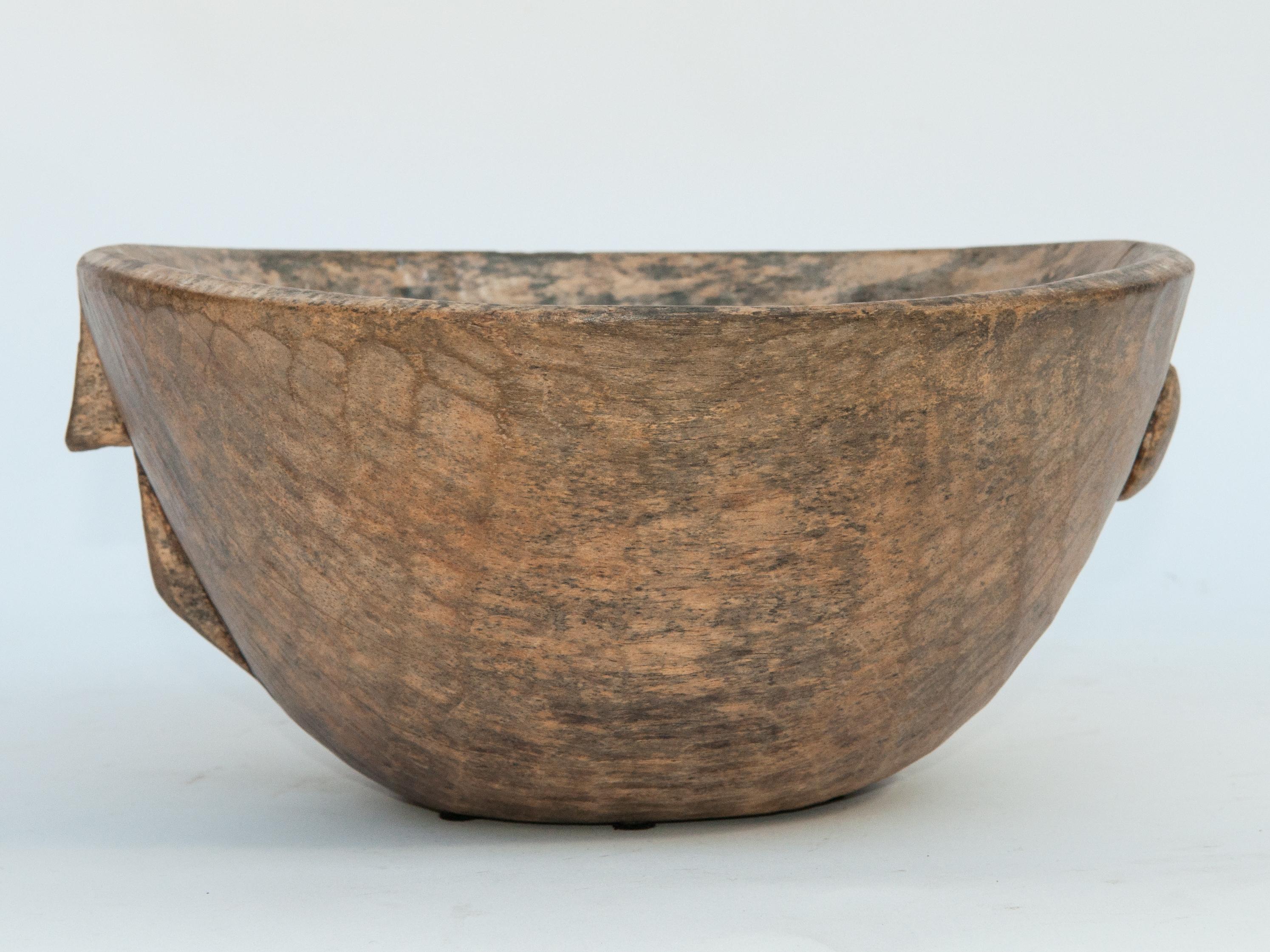 Tribal light colored spalted wooden bowl. Hand hewn. From the Fulani of Niger, mid-20th century.
Offered by Bruce Hughes.
This rustic wooden bowl was fashioned by hand from a single piece of wood using very basic tools. The light colored wood with