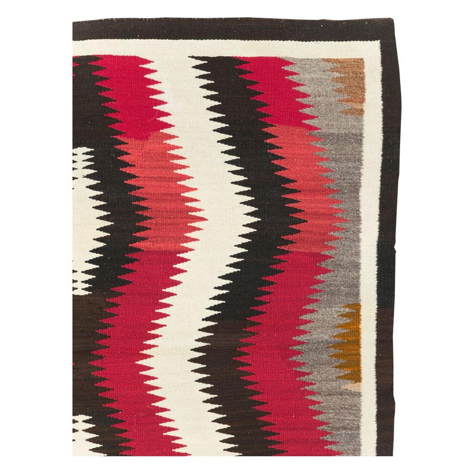 A vintage American flatweave square accent rug handmade by the Navajo tribe during the mid-20th century.

Measures: 4' 8