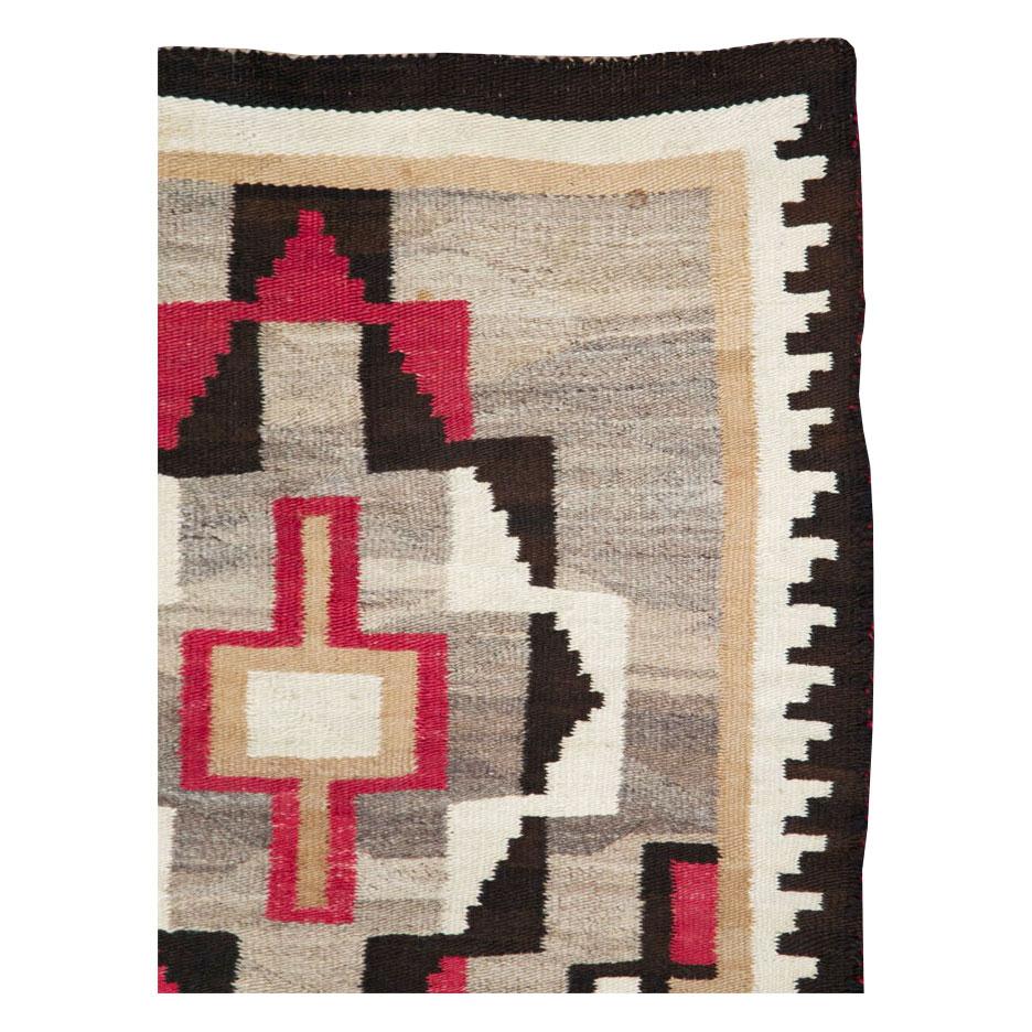 A vintage American flatweave throw rug handmade by the Navajo tribe during the mid-20th century.

Measures: 3' 1