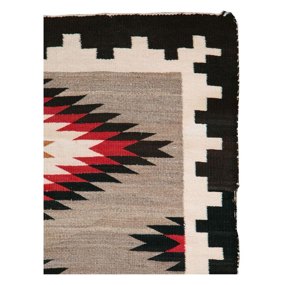A vintage American flatweave throw rug handmade by the Navajo tribe during the mid-20th century.

Measures: 2' 10