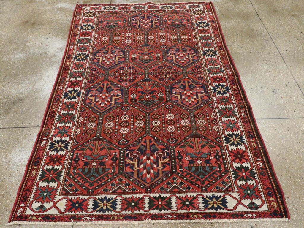 A vintage Persian Bakhtiari tribal accent rug handmade during the Mid-20th Century.

Measures: 4' 5