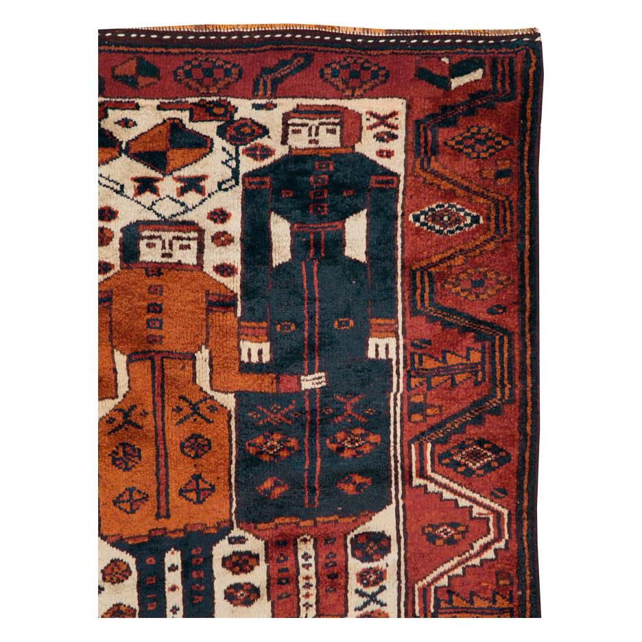 A vintage Persian tribal Bakhtiari accent rug handmade during the mid-20th century with a pictorial design.

Measures: 4' 0