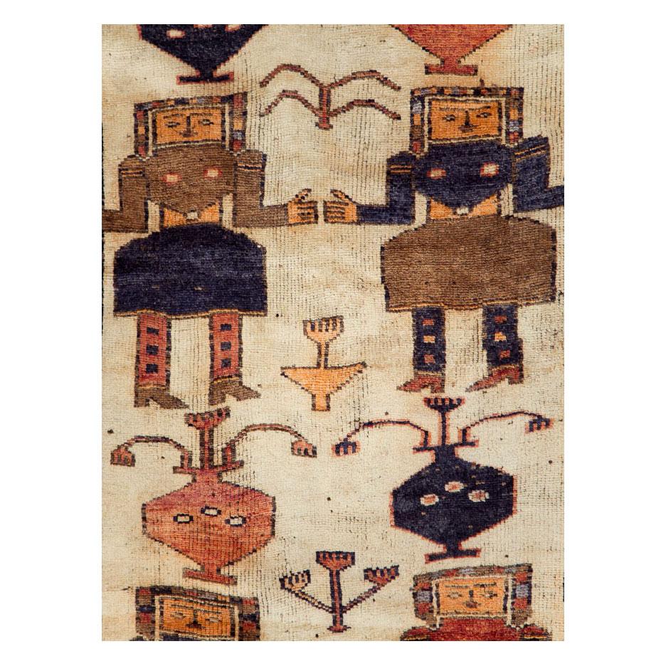 A vintage Persian gallery format rug handmade by the Bakhtiari tribe during the mid-20th century with a pictorial design of androgynously drawn female figures.

Measures: 4' 5