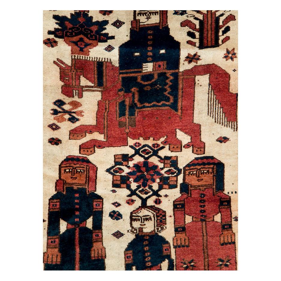 A vintage Persian gallery format rug handmade by the Bakhtiari tribe during the mid-20th century with a pictorial design of naively drawn androgynous figures.

Measures: 4' 6