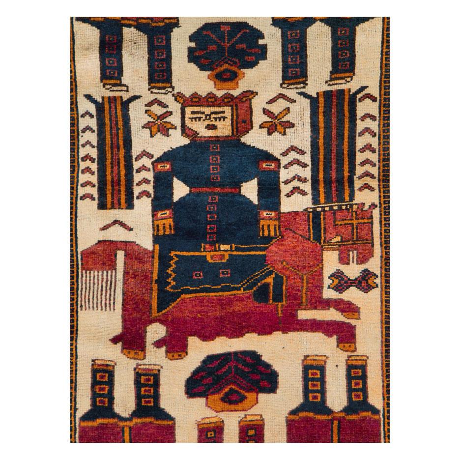 A vintage Persian Bakhtiari tribal rug in gallery format handmade during the mid-20th century with a pictorial design.

Measures: 4' 4