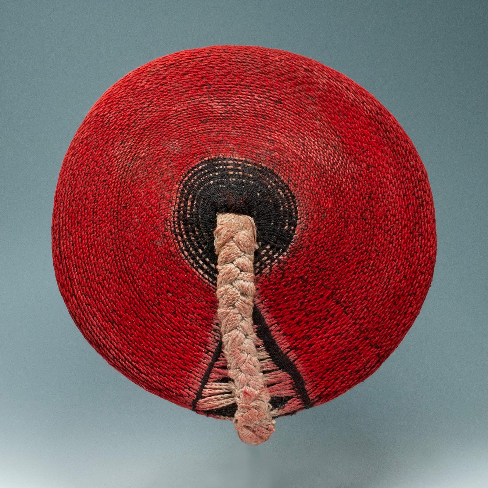Mid-20th century Tribal Zulu women's woven red cotton hat, Isicholo, from South Africa

This woman's cotton Isicholo hat is a beautiful example of the hats worn during special ceremonies by married Zulu women. Coated with red ochre, it has a