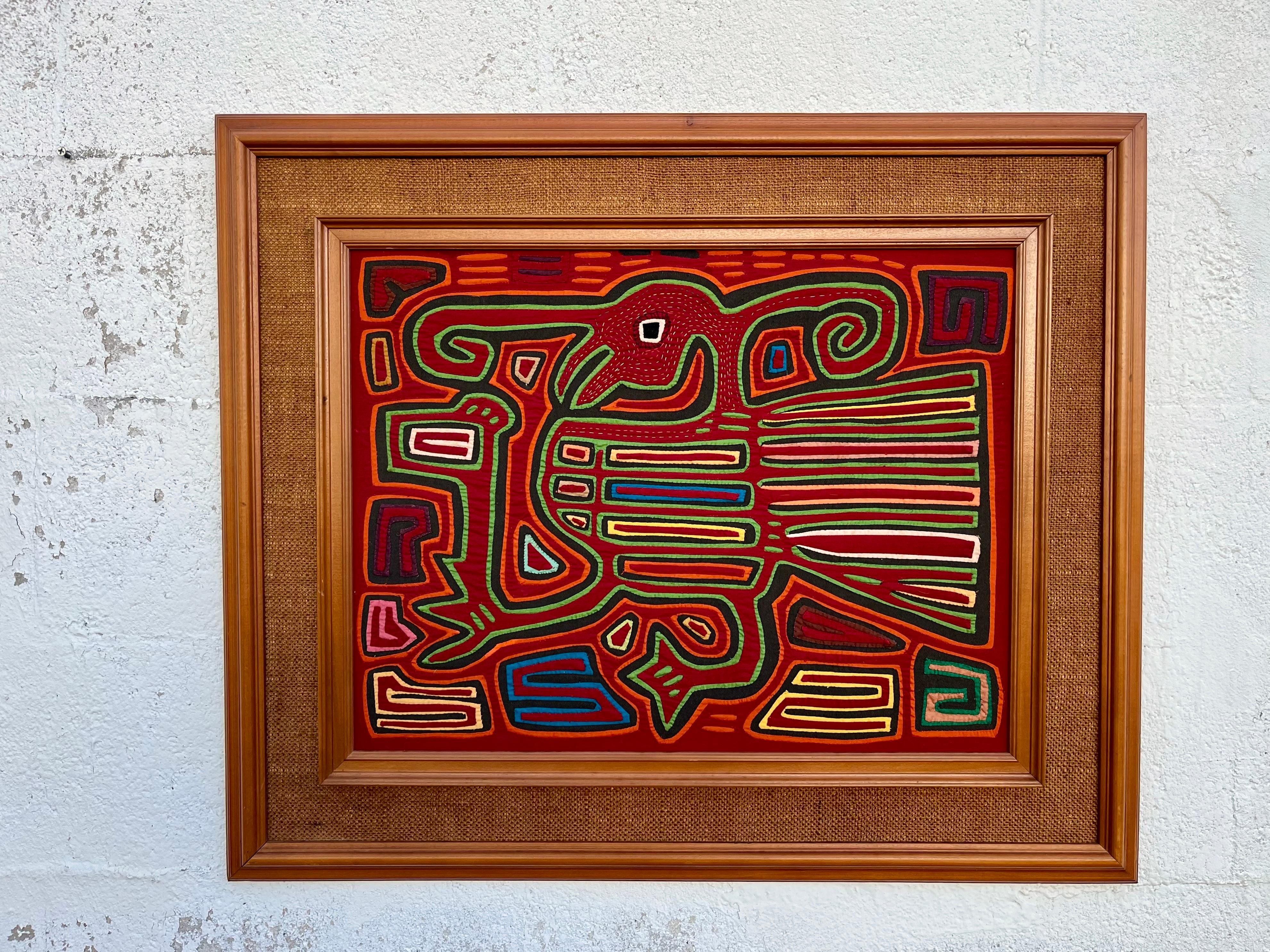 Large Vintage Tribal Mola Framed Handcrafted Textile Art. Circa 1960s
Mola is a traditional textile craft made from layers of colored fabric, stitched and cut using appliqué techniques to create patterns and pictures. Handmade by Kuna tribe on the