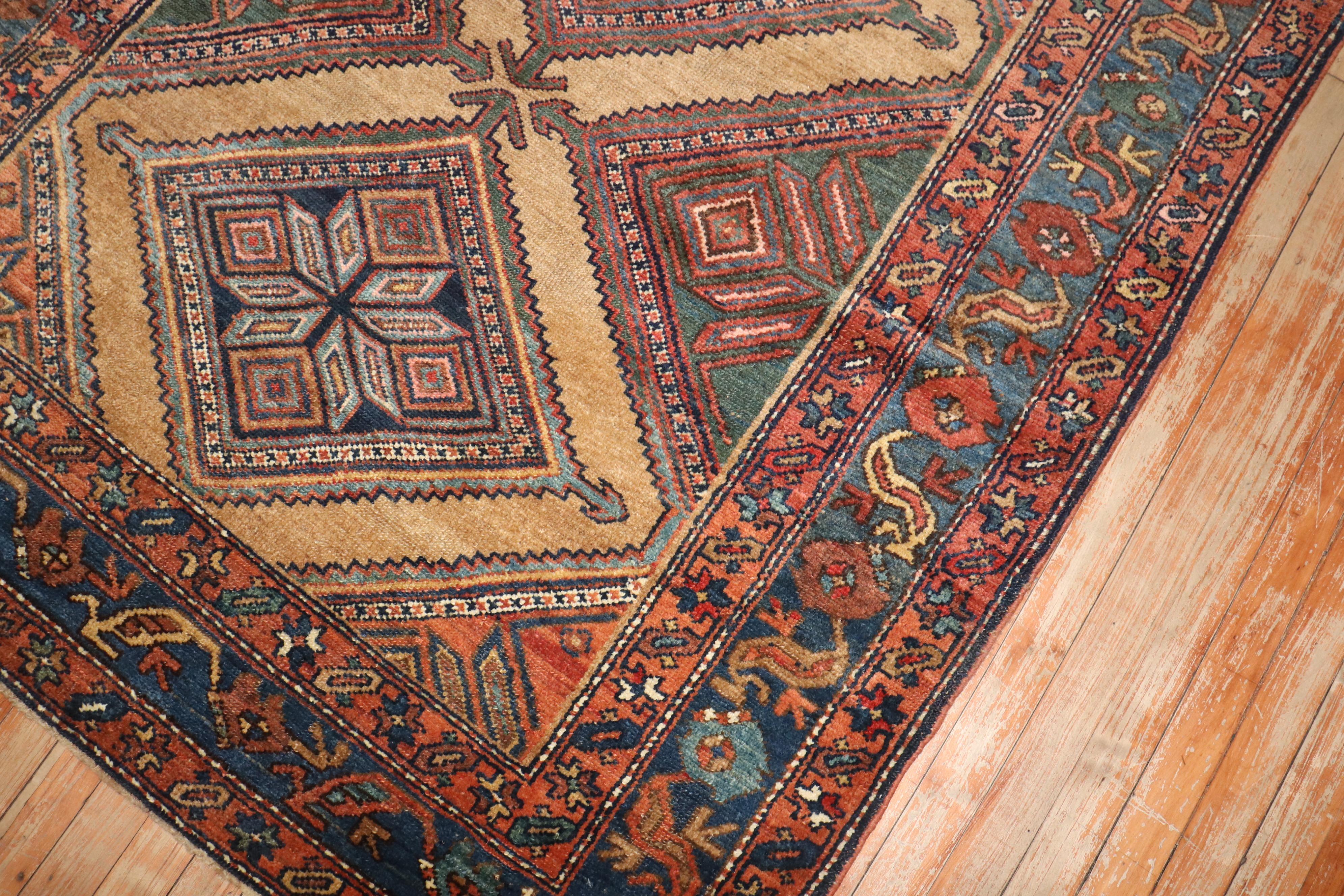 An early 20th century tribal highly decorative Persian Serab wide runner. Great quality and great condition. Accents in blue brow and green on camel brown tone ground

Measures: 4'8