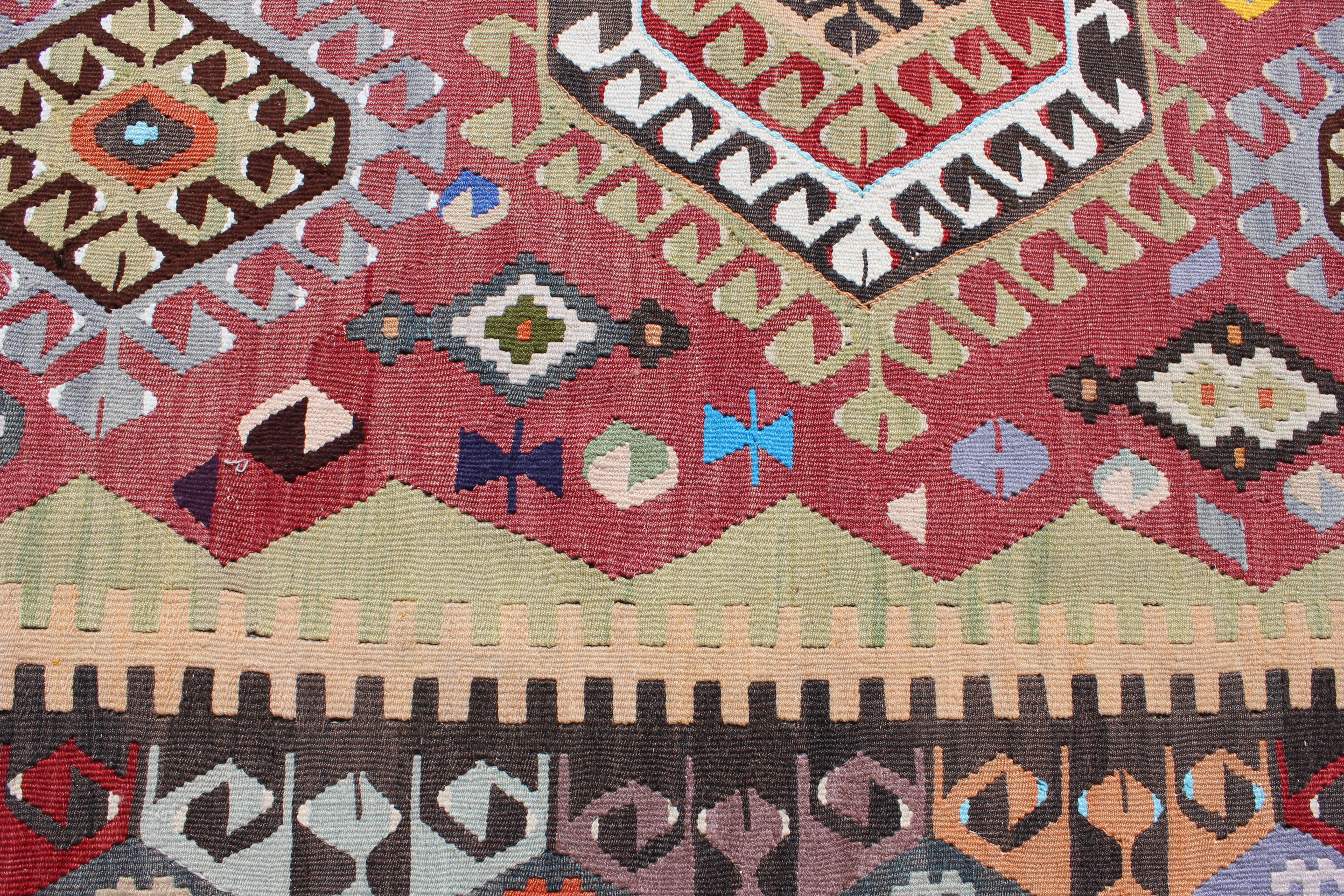 Hand-Woven Tribal Print Wool Turkish Kilim with Red, Brown, and Blue Tones