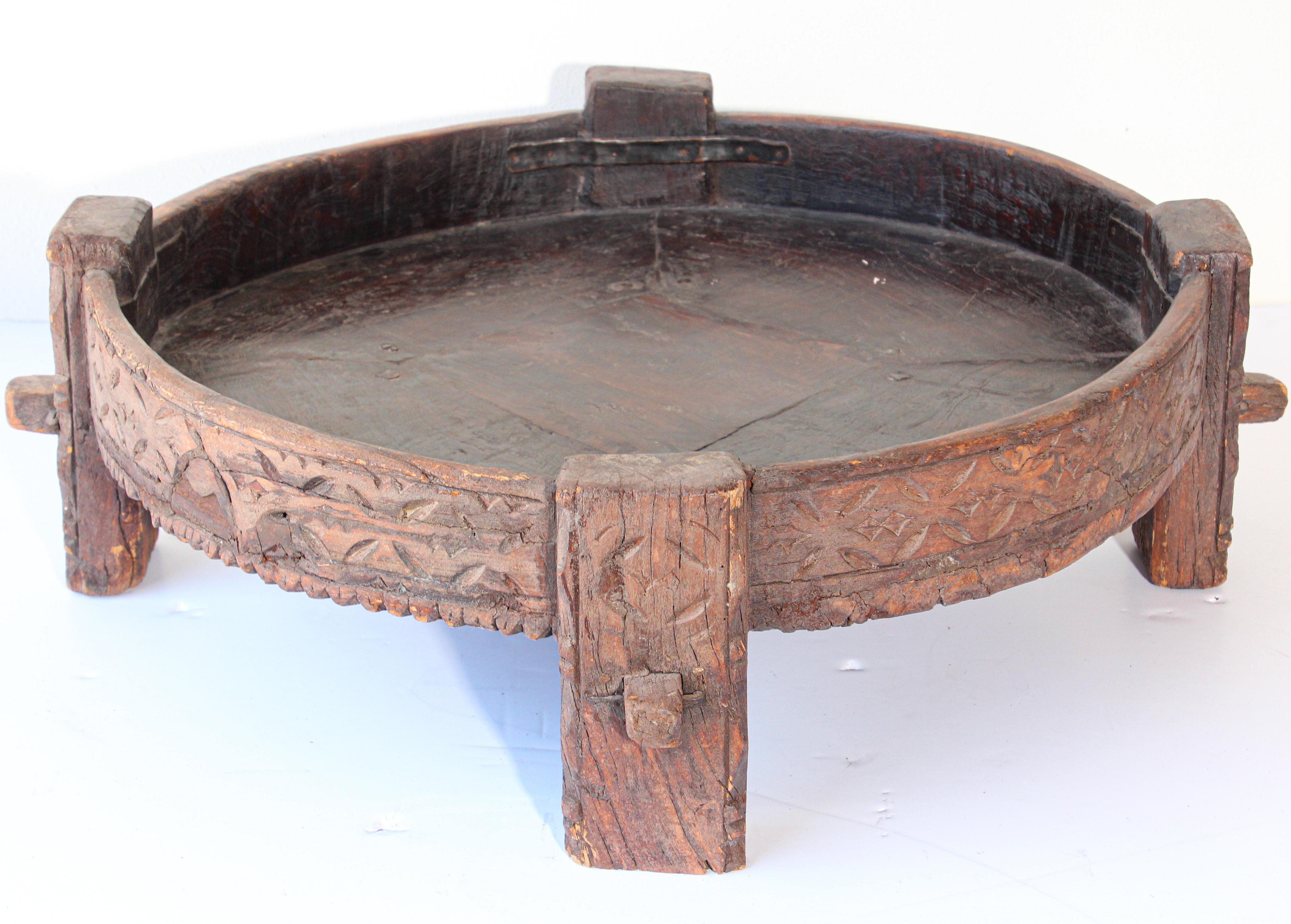 Large antique hand carved wood Indian grinder tribal teak table.
Walnut color hand carved with geometric tribal design.
Handcrafted of wood and iron, hand carved with geometric ethnic tribal design.
Very sturdy rustic wood table with nice patina,