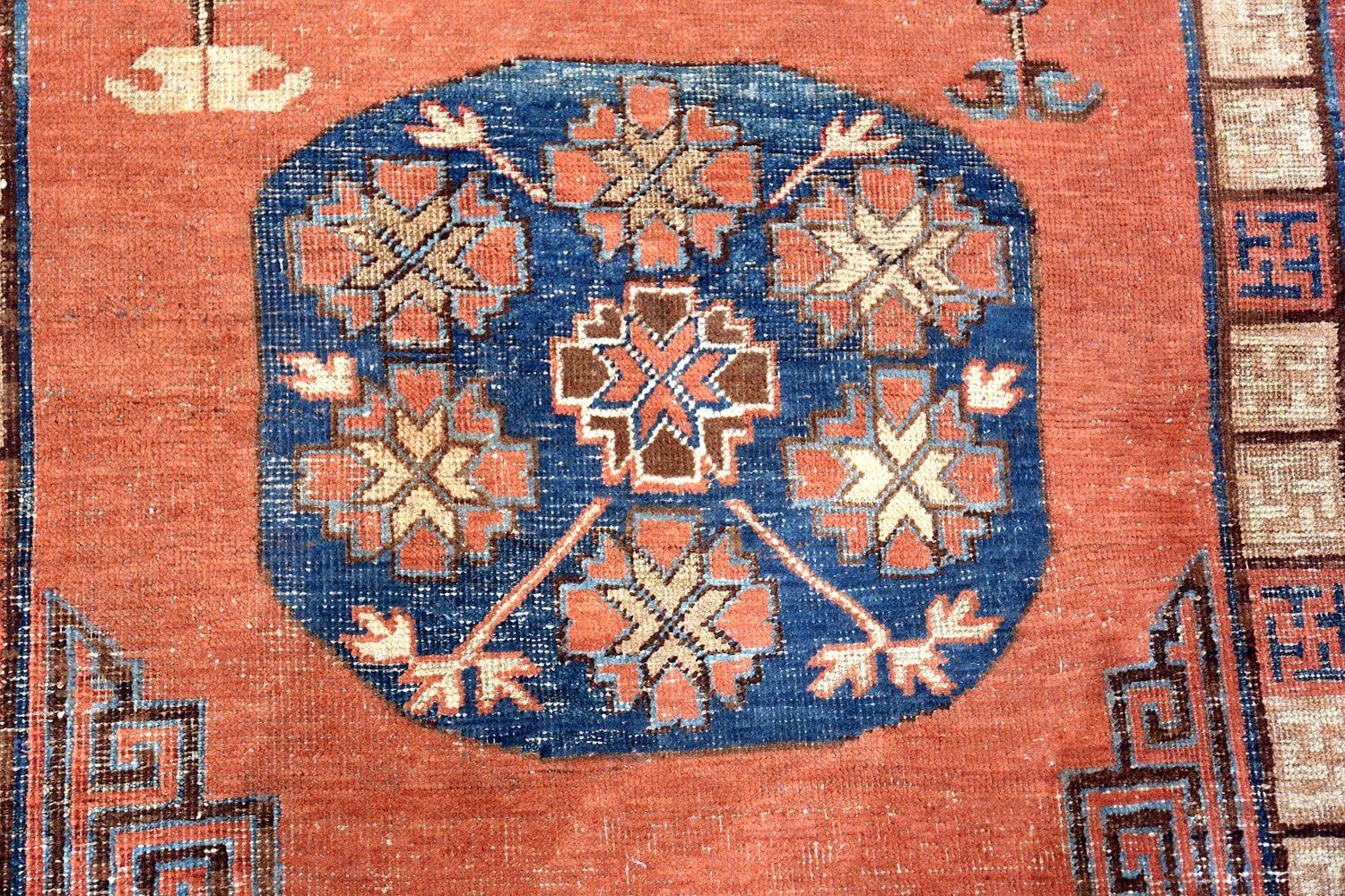 Beautiful tribal and rust colored background pomegranate design antique Khotan rug, Country of Origin / rug type: East Turkestan rugs, date circa early 19th century.