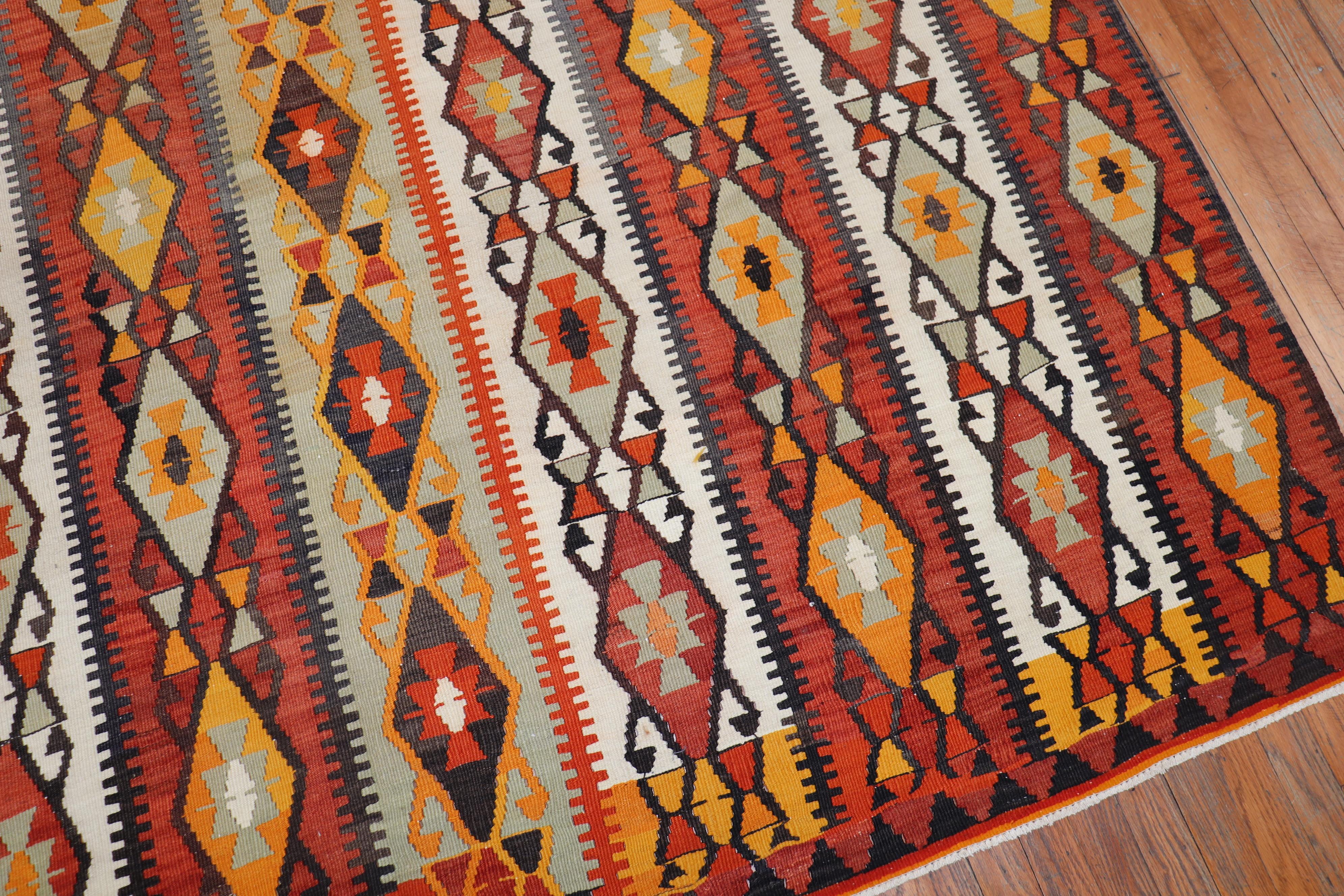 One of a kind, hand knotted Turkish tribal Kilim flat-weave from the second quarter of the 20th century with a rustic all-over geometric design predominantly in brick orange.

Measures: 7'9