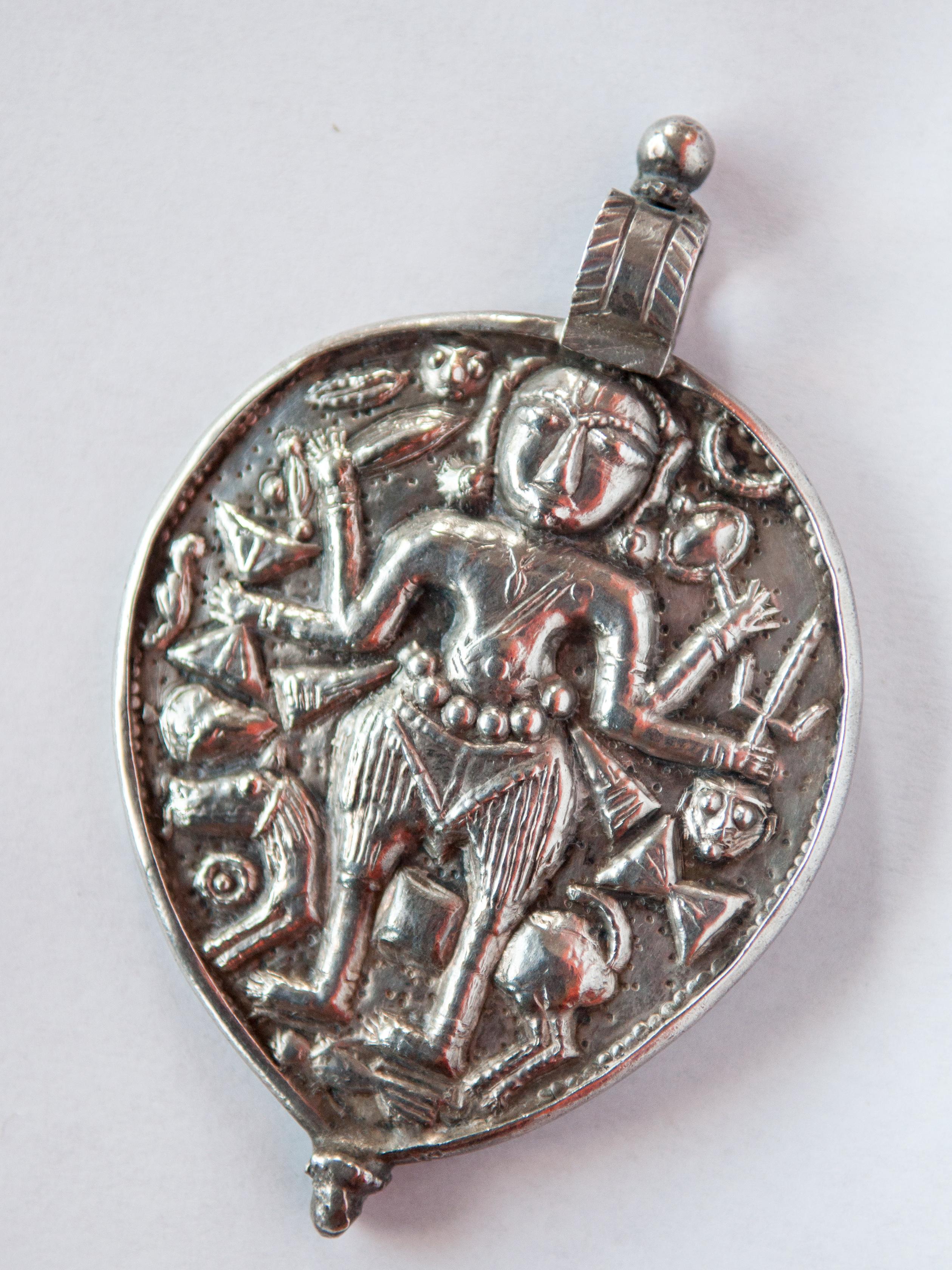 Tribal Silver Amulet Pendant from India depicting Kali. Repousse work. Mid-20th Century.
Kali is the fearsome and fearless aspect of Shakti, the great Goddess, consort of Shiva, and the manisfesting energy of creation in Indian religious cosmology.