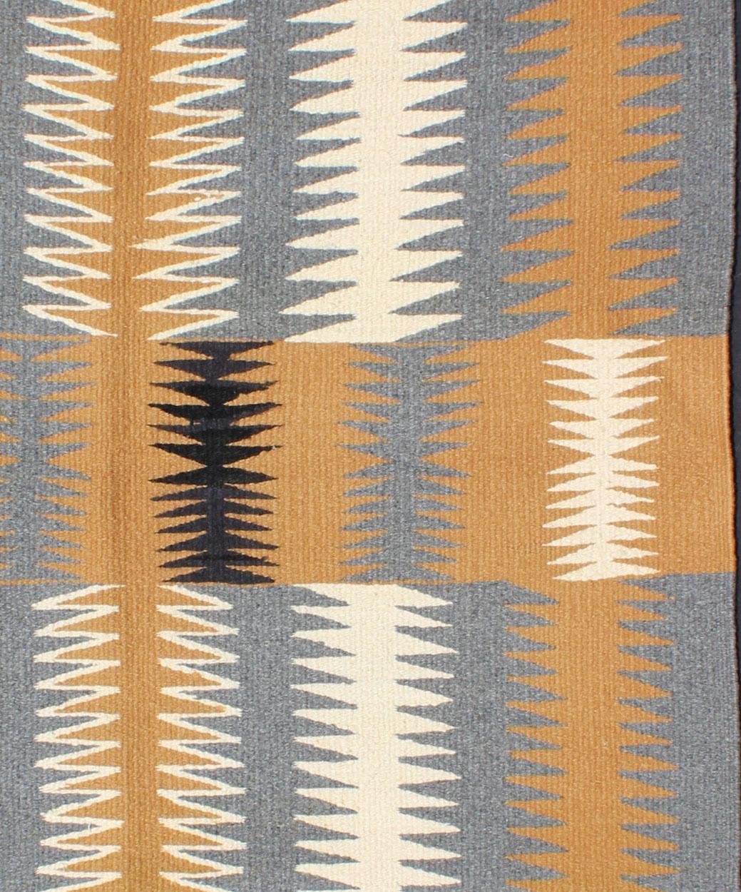 This intriguing antique Navajo Kilim, circa 1940 was woven in the United States during the first half of the 20th century. The exciting and unique composition boasts a captivating geometric composition with an all-over zig-zag design. The range of