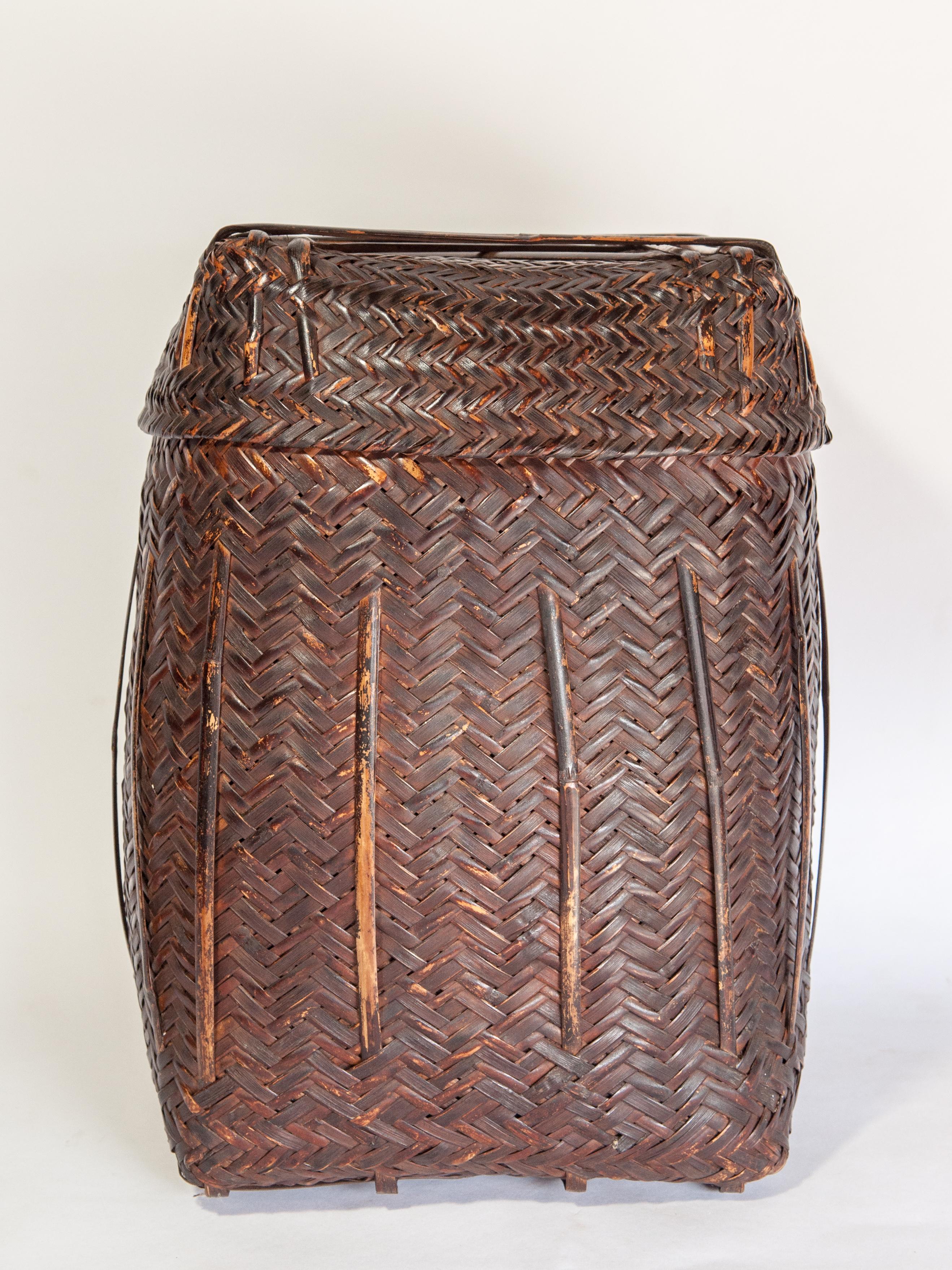 Tribal storage basket box with Lid from the Magar of Nepal, mid-20th century.
This rustic bamboo basket was primarily used as a storage basket for household goods. It comes from the Magar, an important ethnic group of the hills and mountains of