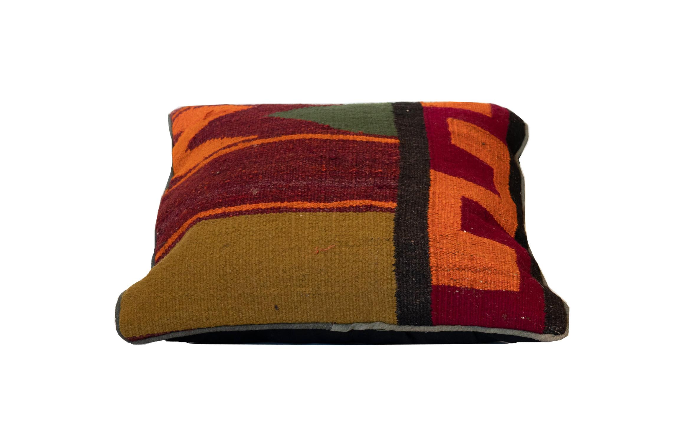 Using the conventional Kilim, flat-weave technique, this traditional vibrant Kilim cushion cover has been handwoven with hand-spun wool. This fantastic piece features an abstract geometric design, including zig-zags and striped woven in a deep