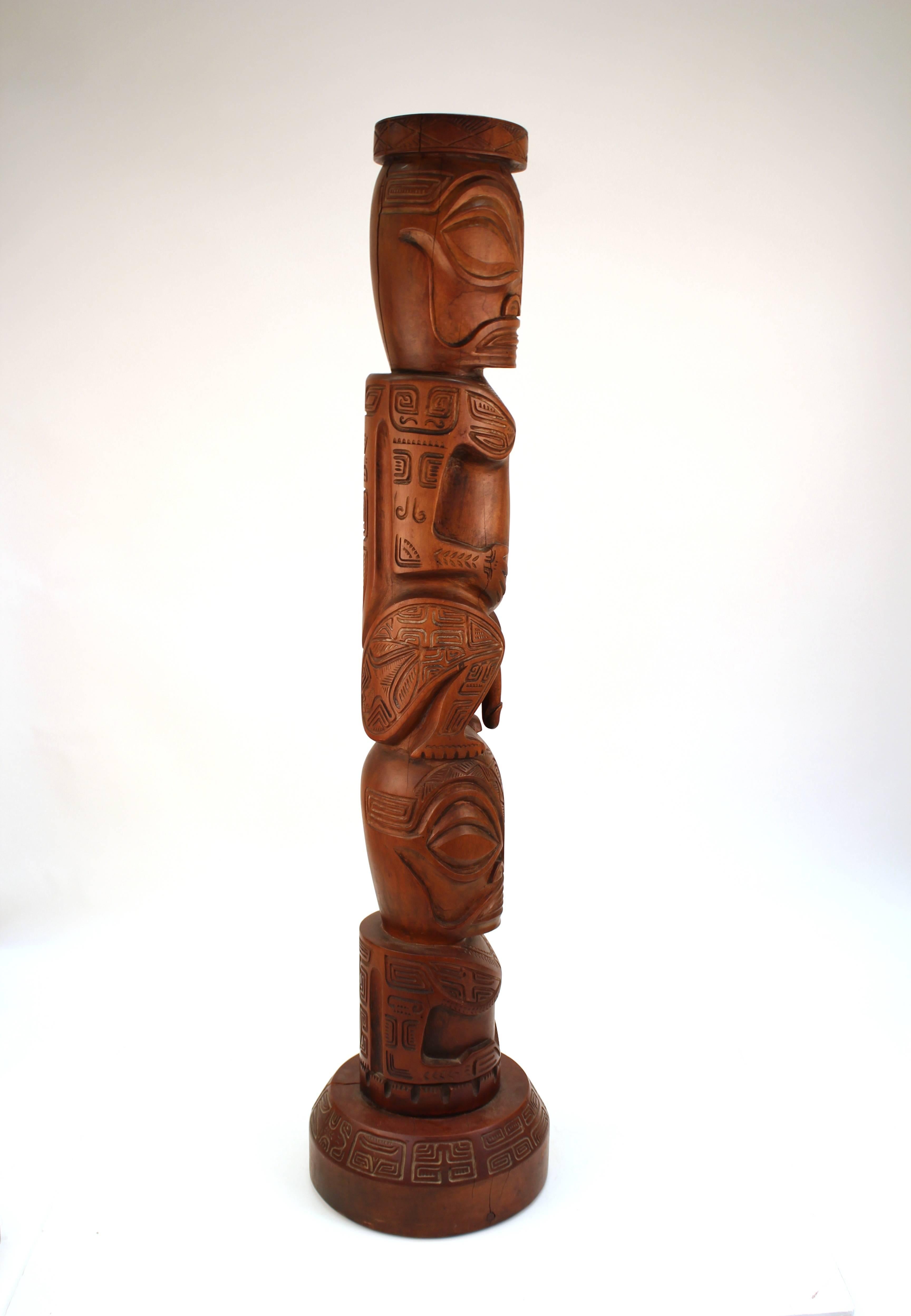 grands poteaux de bois aux figures sculptees