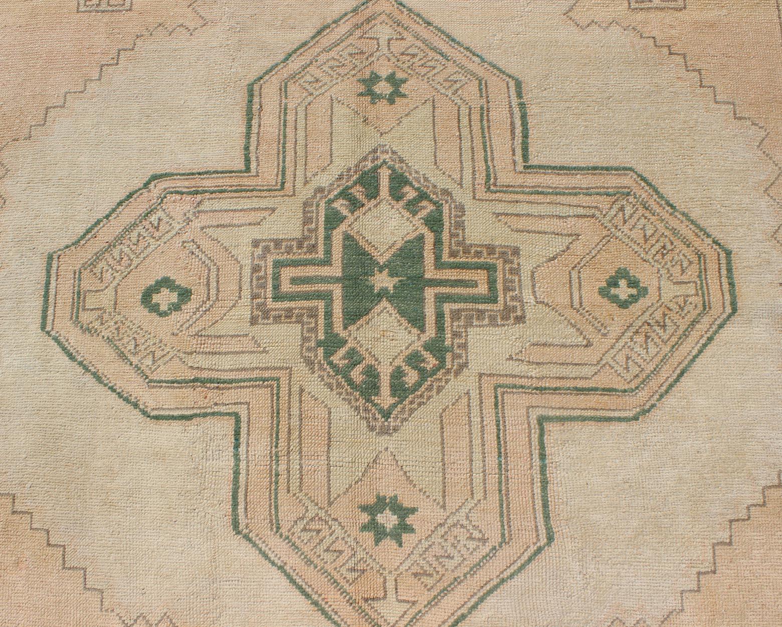 Mid-20th Century Tribal Turkish Oushak Rug in Green, Light Peach and Cream with Cross Medallion For Sale